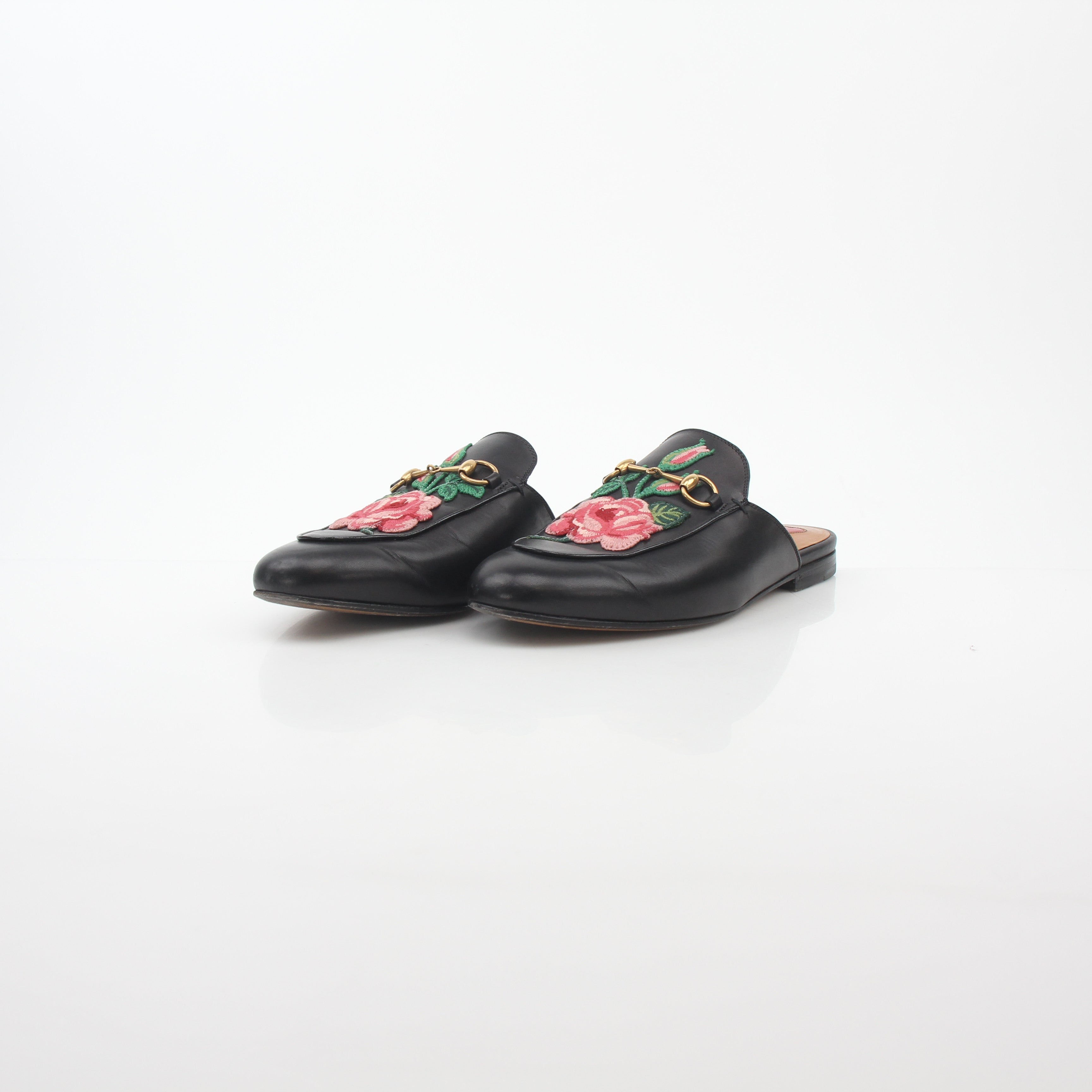 Gold & Beyond Gucci black Princetown leather mule with rose embroidery, stylish slip-on shoes for women.