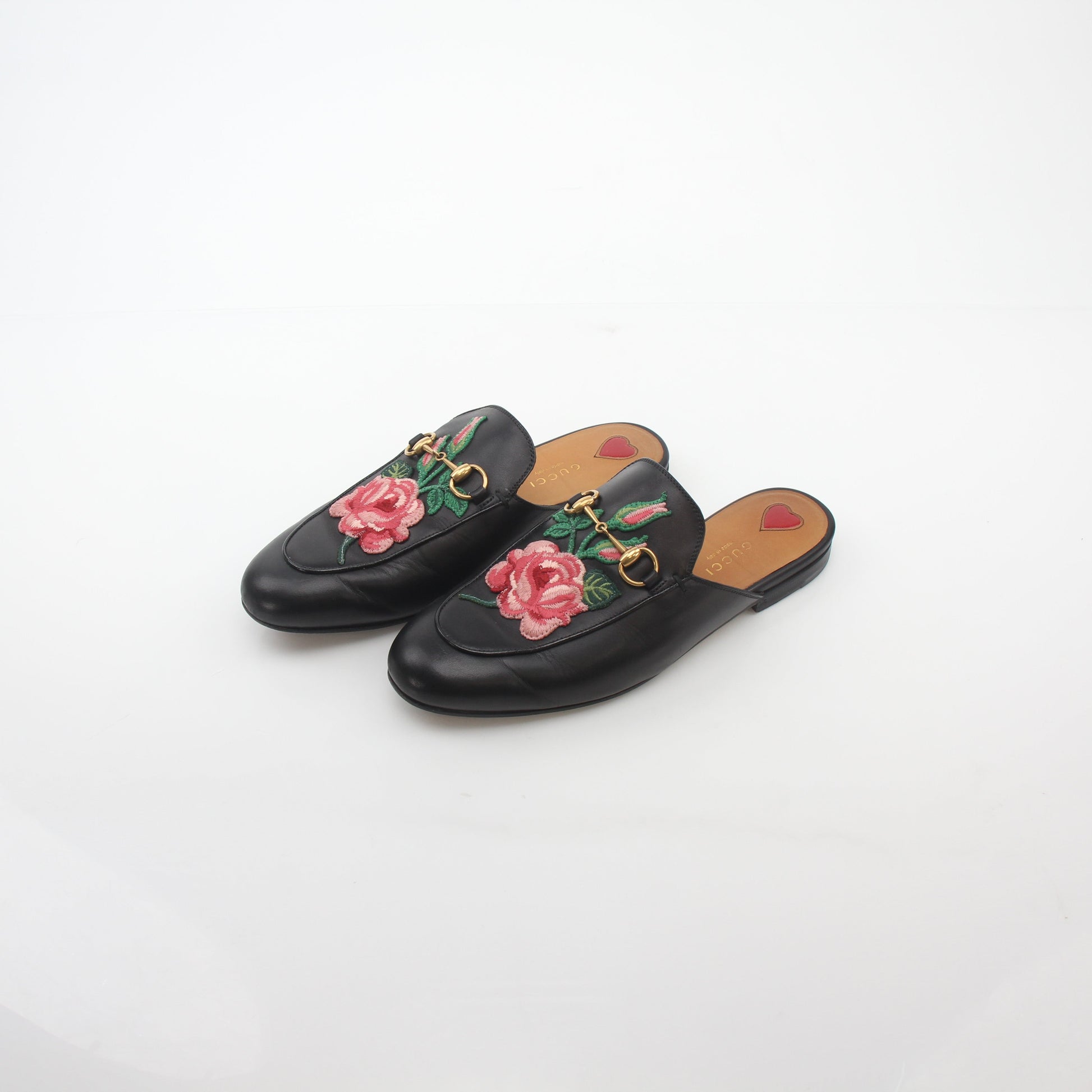Black Gucci Princetown leather mule shoes with rose embroidery, featuring a slip-on design and gold accents.