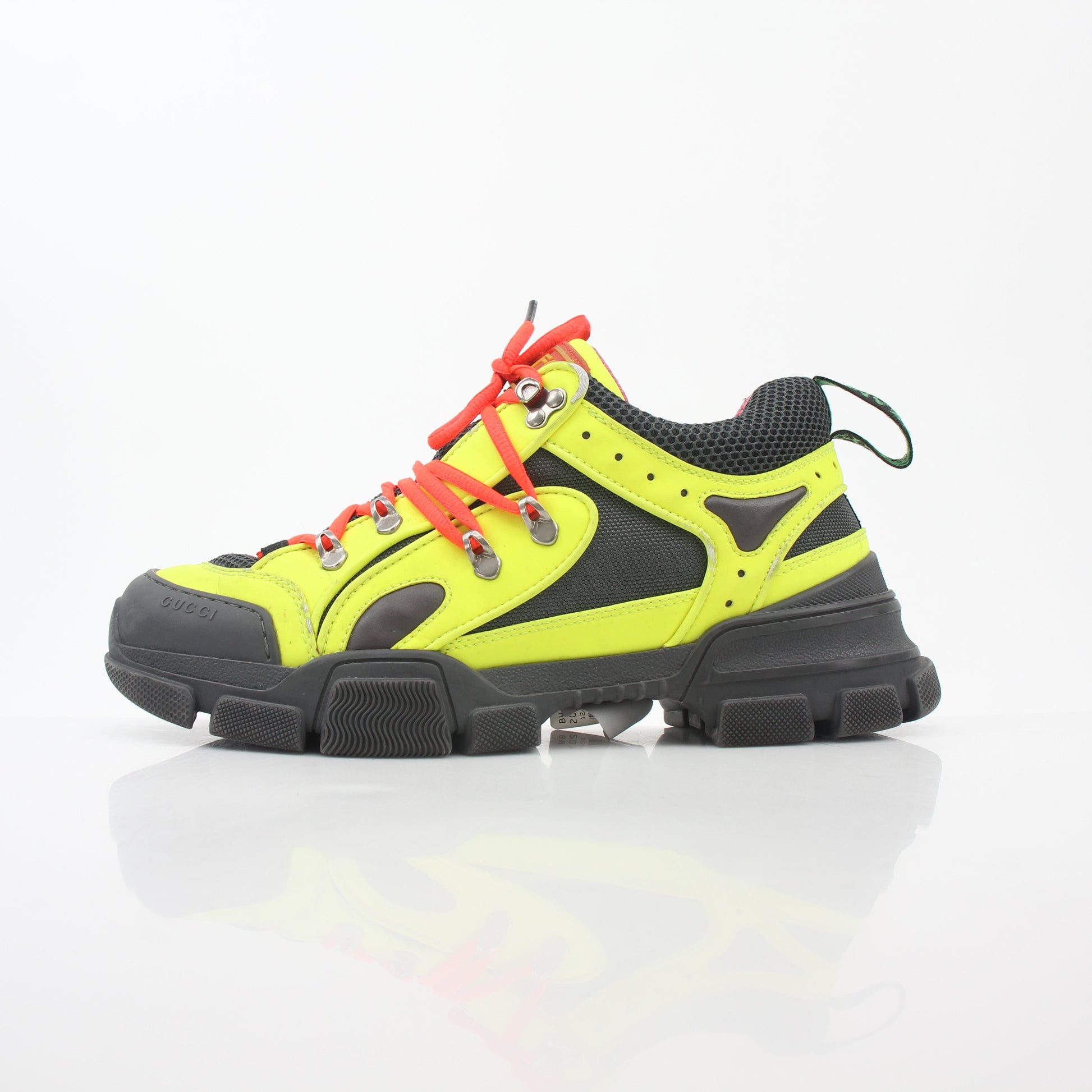 Gold & Beyond Gucci Neon Yellow Flashtrek reflective sneakers with vibrant yellow and black accents, showcasing sporty shoe design.
