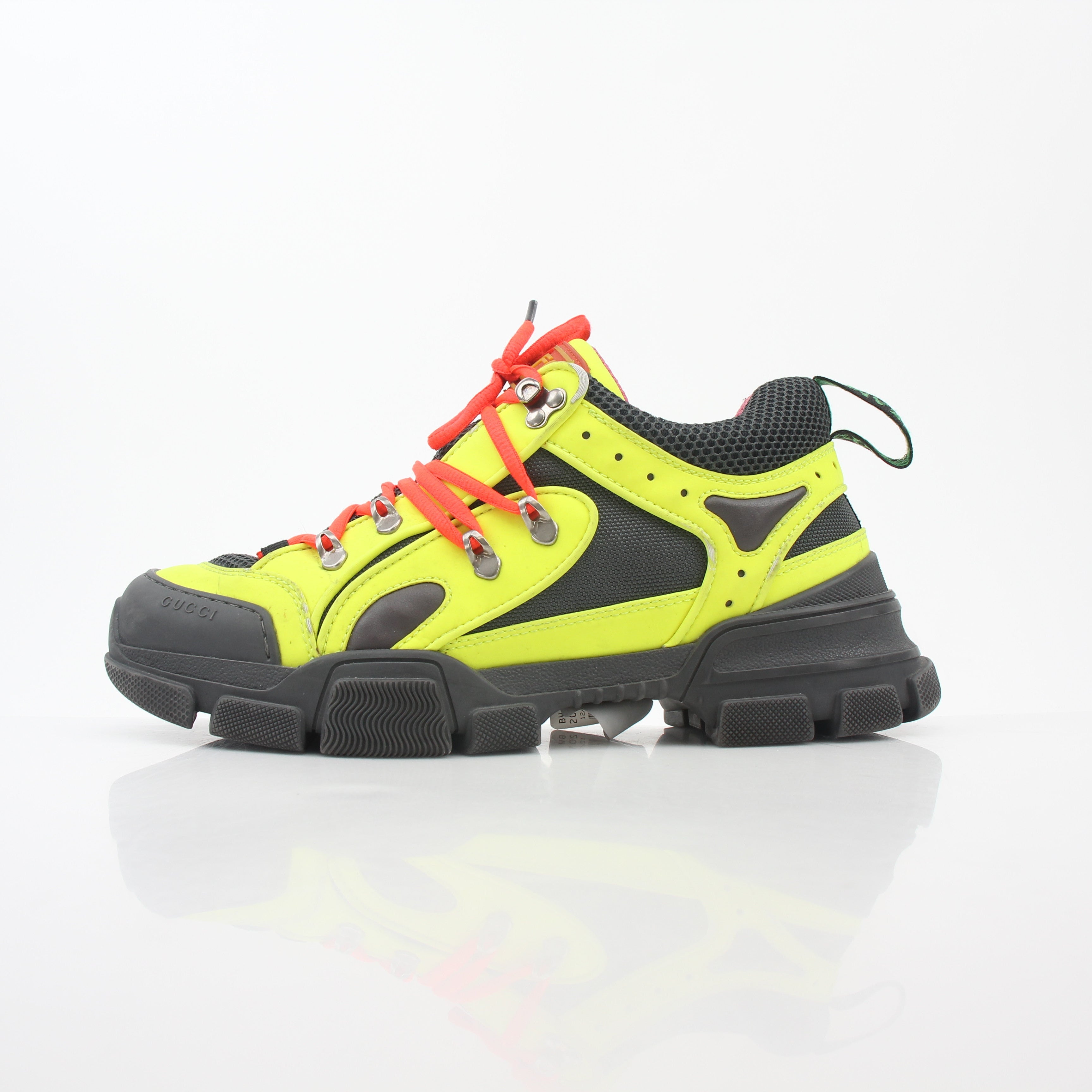 Gold & Beyond Gucci Neon Yellow Flashtrek reflective sneakers with vibrant yellow and black accents, showcasing sporty shoe design.