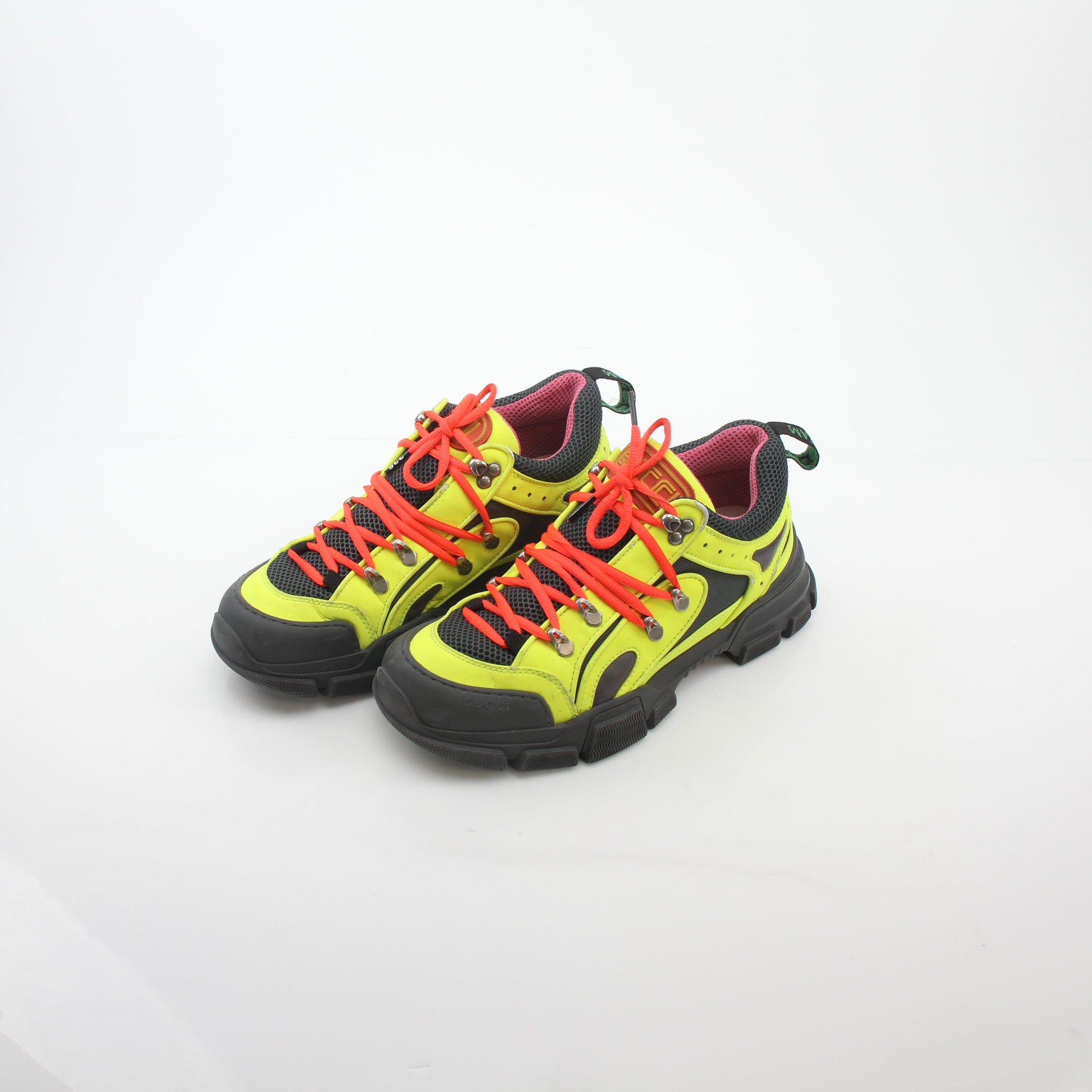 Gold & Beyond Gucci Neon Yellow Flashtrek reflective sneakers showing bright yellow shoes with reflective details and black accents.