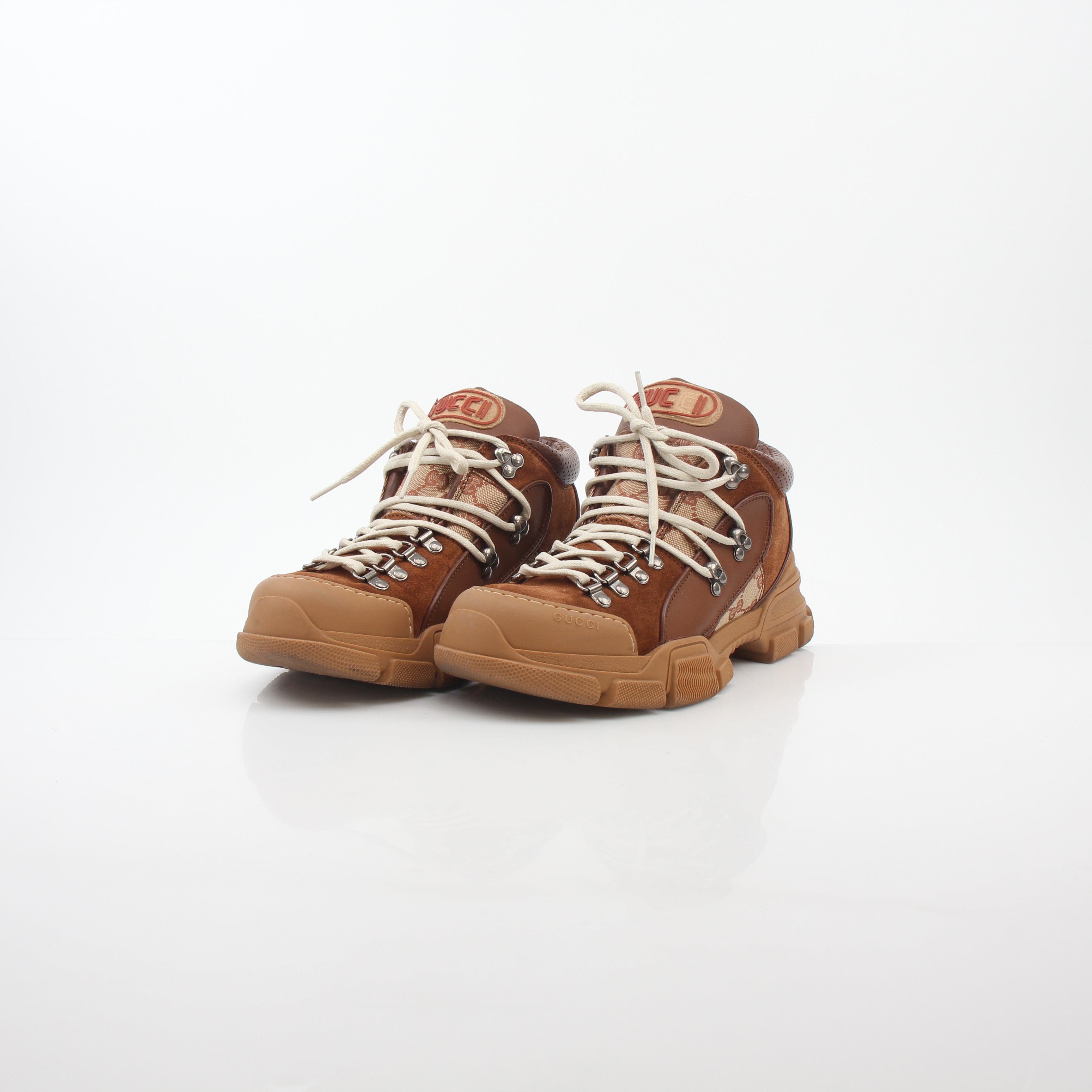 Gold & Beyond Gucci Brown GG Canvas Flashtrek mid-top sneakers with lace-up closure and rubber sole, stylish and casual footwear.