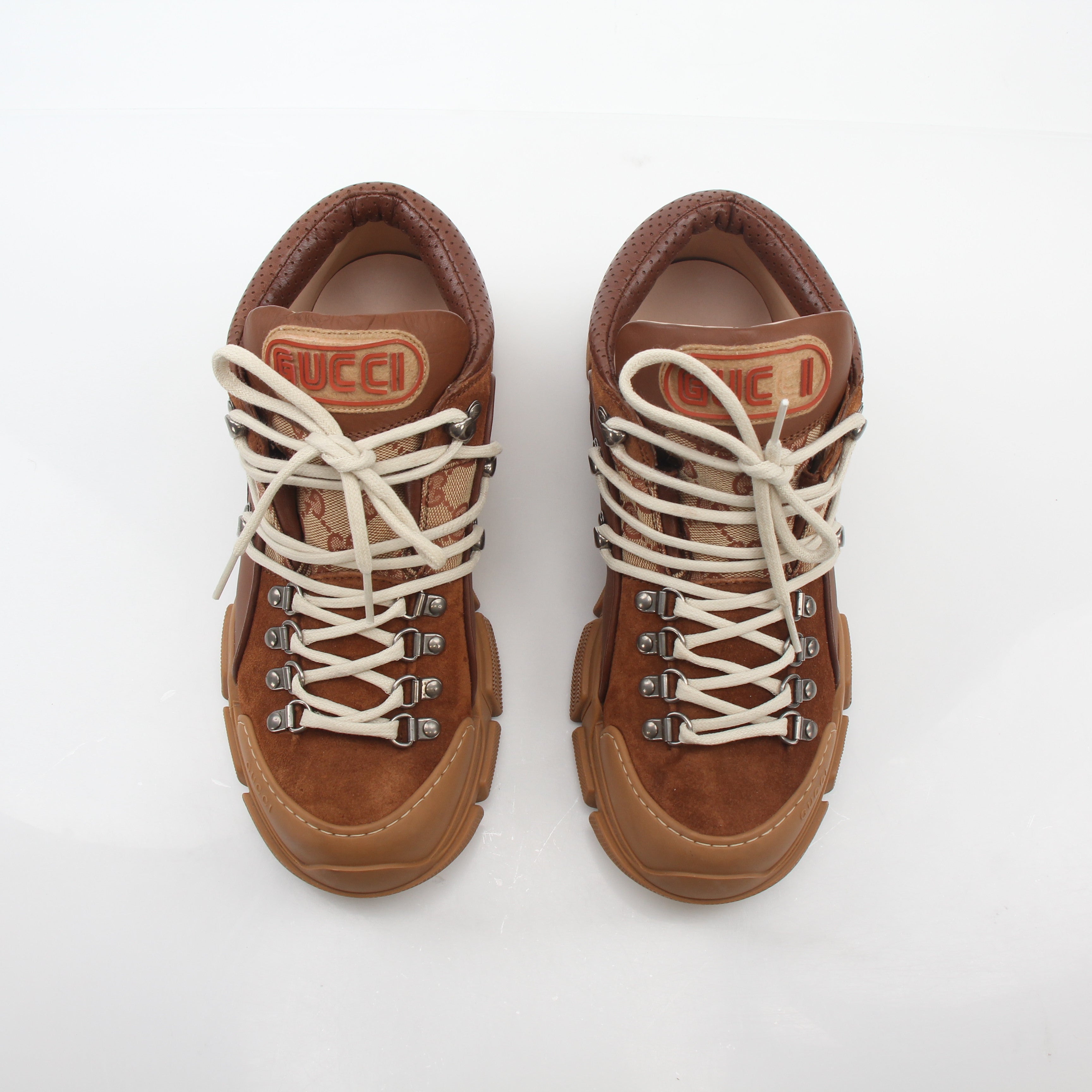 Gold & Beyond Gucci brown GG canvas Flashtrek mid-top sneakers with white sole and lace-up design, stylish casual shoes for men.