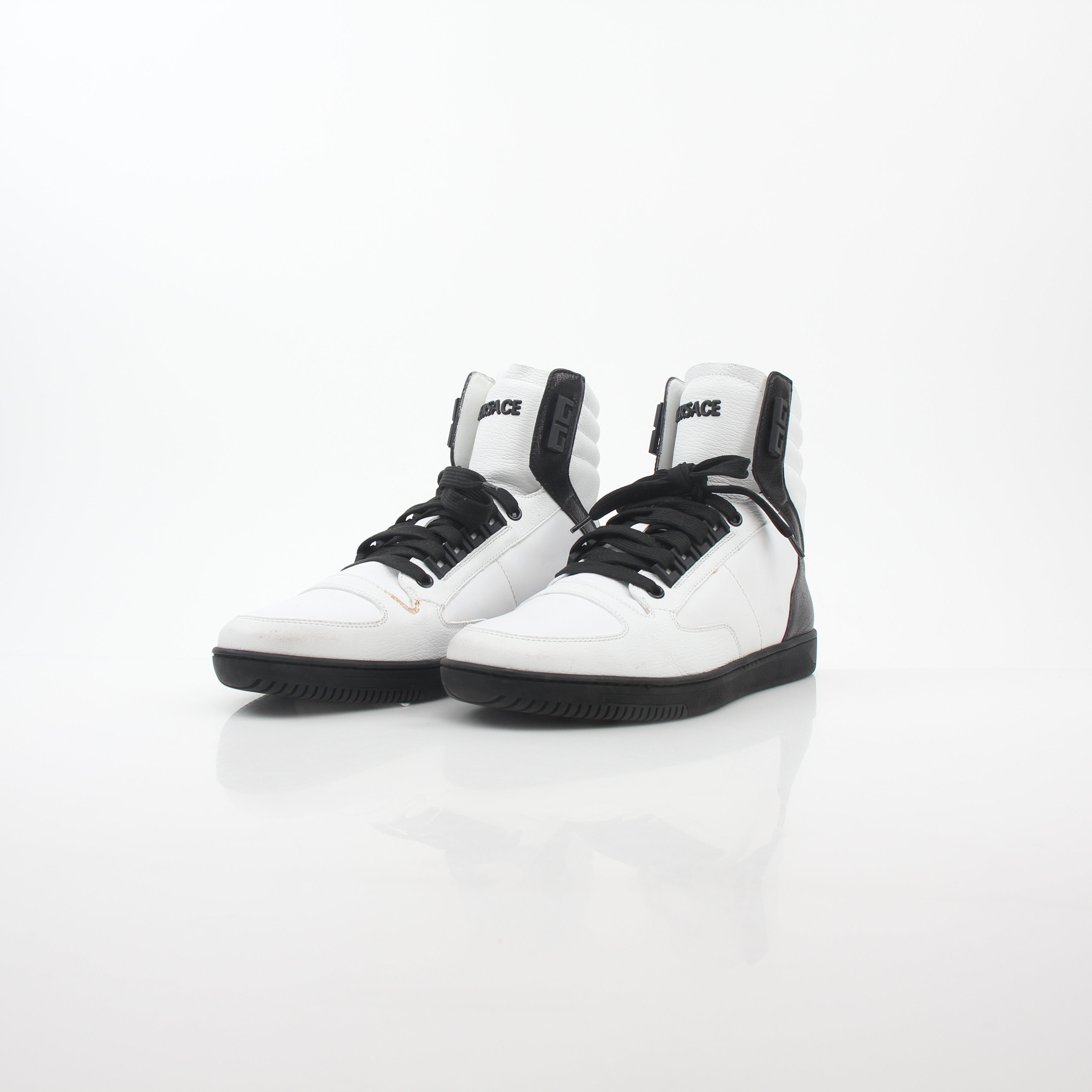 Versace White and Black Greca Key high-top sneakers by Gold & Beyond, featuring signature Greek key design and stylish shoe details.