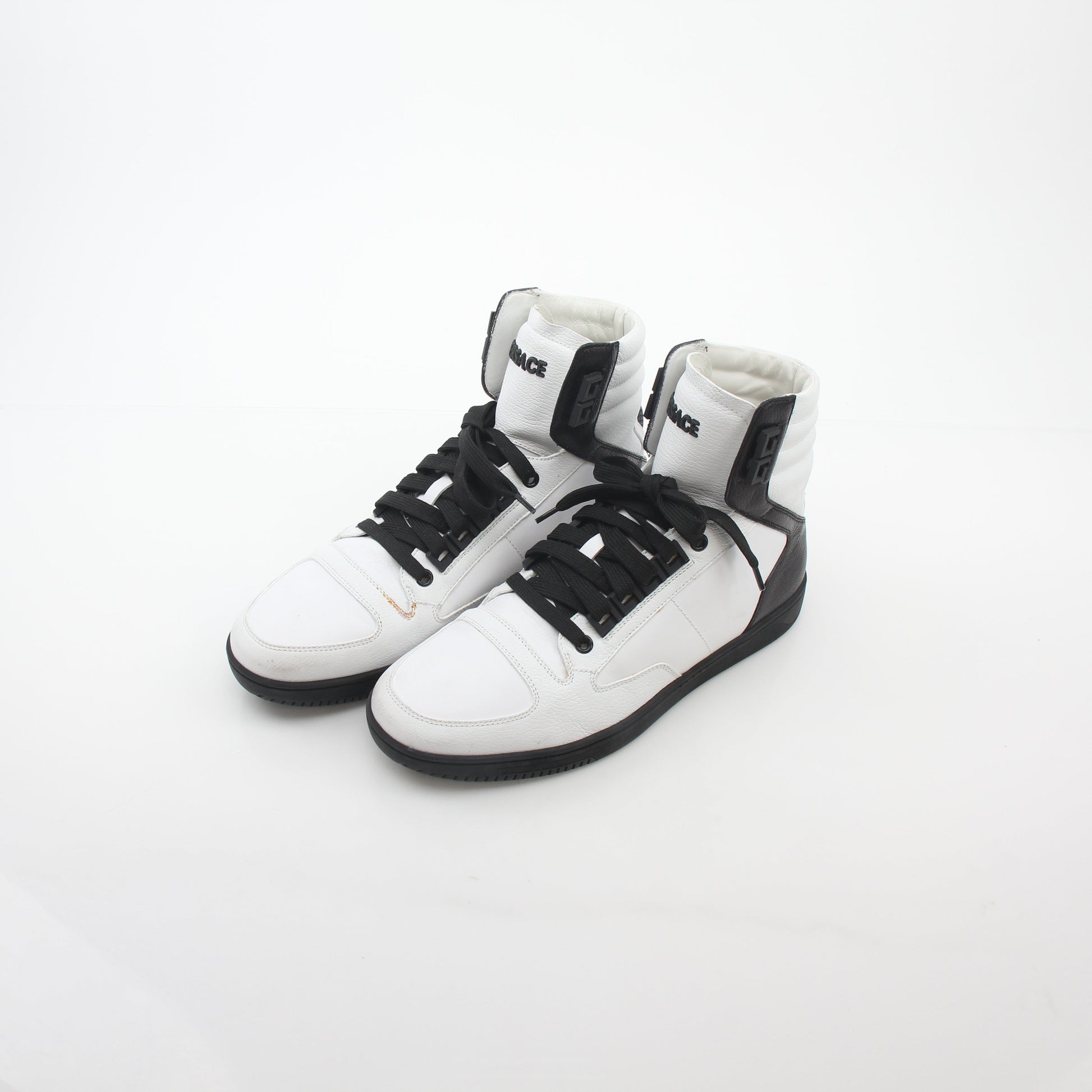 Gold & Beyond Versace white and black Greca Key high-top sneakers with stylish design and logo details.