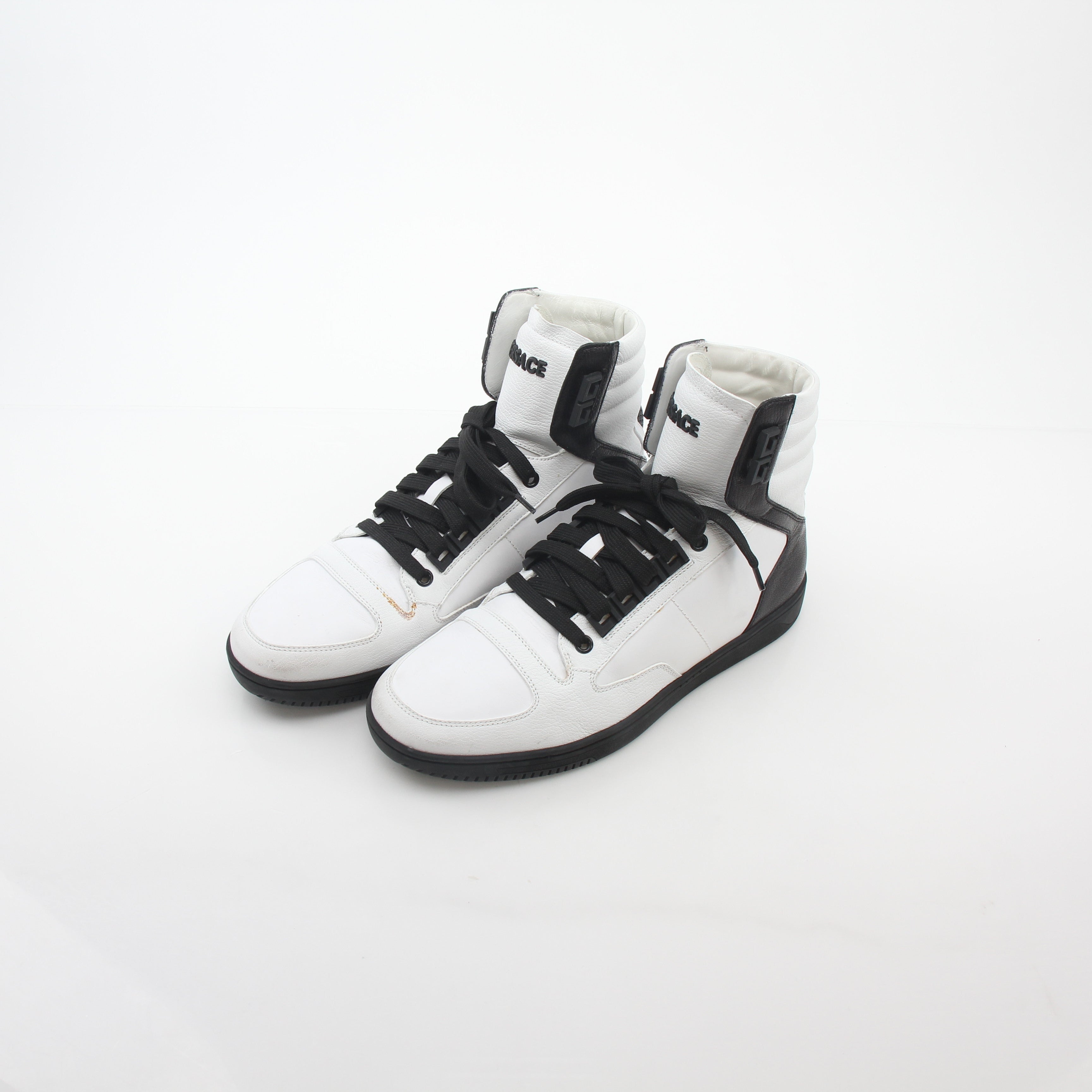 Gold & Beyond Versace white and black Greca Key high-top sneakers with stylish design and logo details.