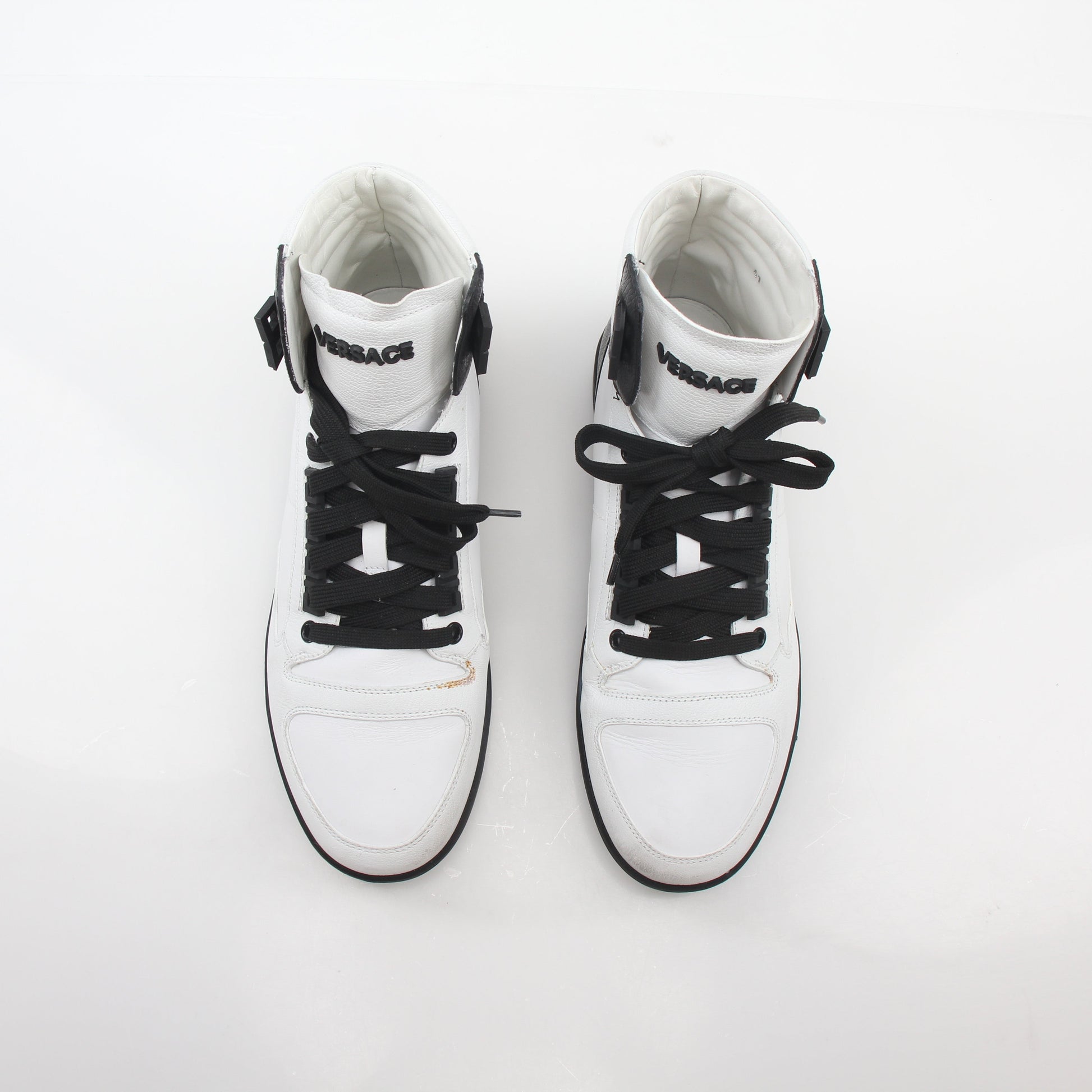 Gold & Beyond Versace white and black Greca Key high-top sneakers with logo details, stylish shoes for casual wear.