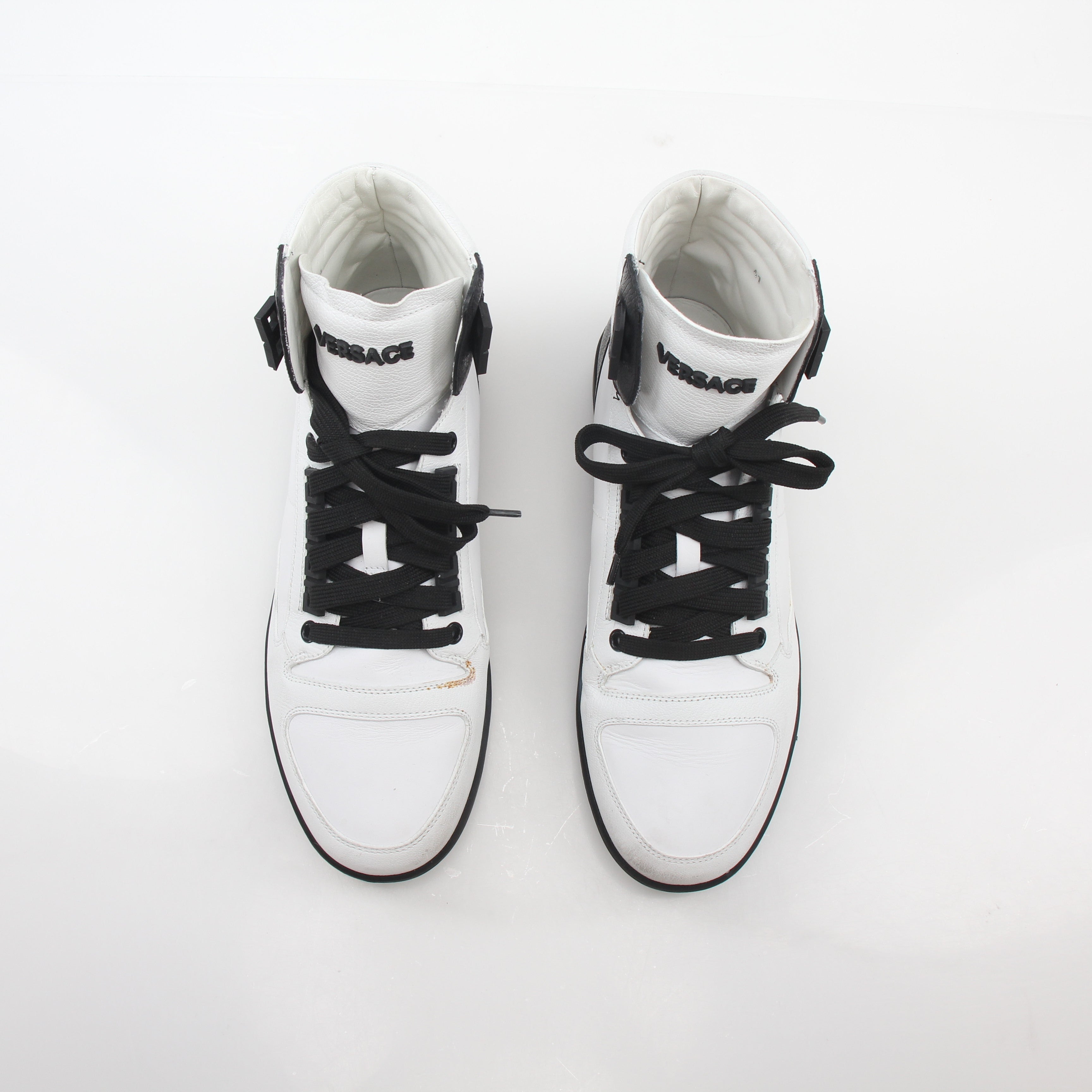 Gold & Beyond Versace white and black Greca Key high-top sneakers with logo details, stylish shoes for casual wear.