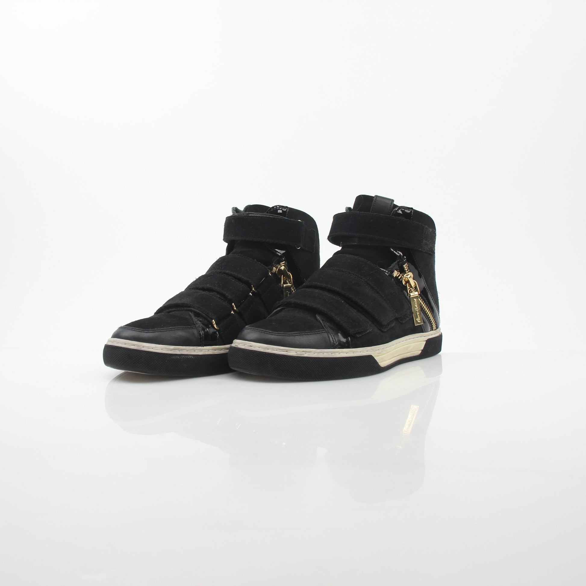 Pierre Balmain black multi-strap high-top sneakers with chunky soles and stylish design, worn by a person standing on a tiled floor.