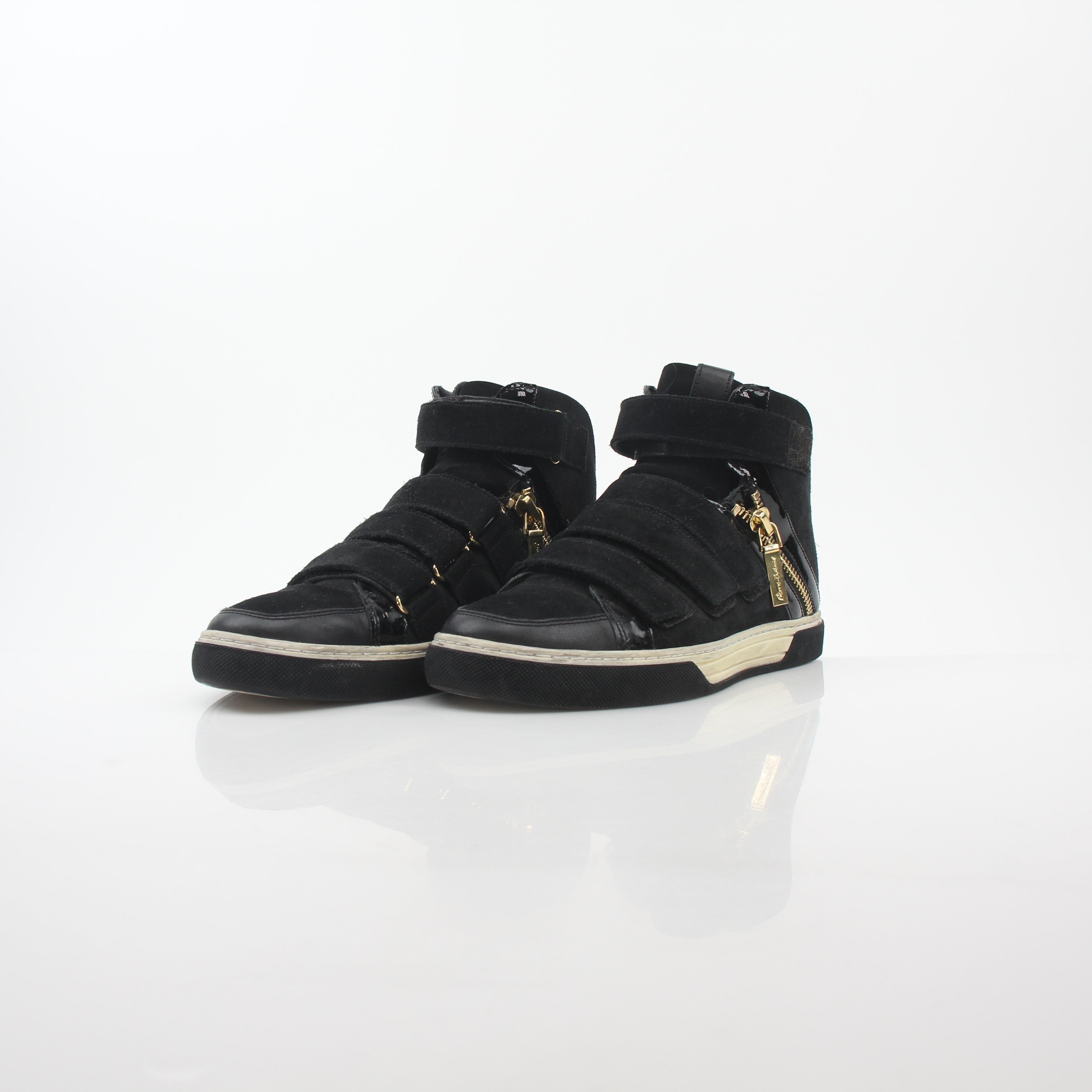 Pierre Balmain black multi-strap high-top sneakers with chunky soles and stylish design, worn by a person standing on a tiled floor.