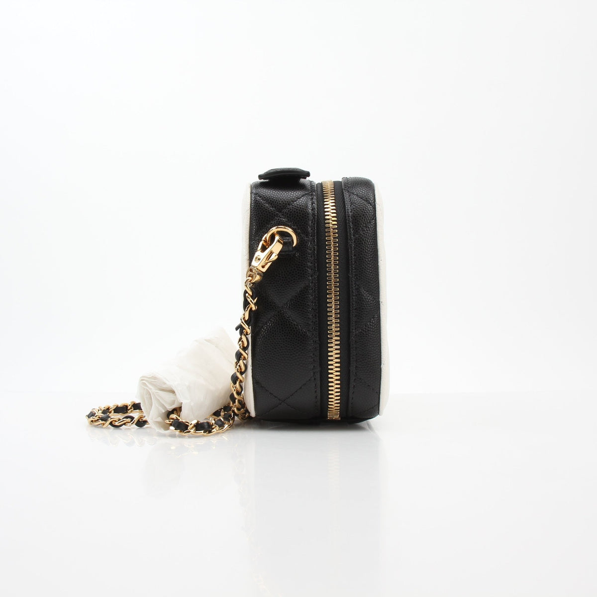 Gold & Beyond Chanel white and black small CC filigree vanity case with intricate design and compact size.