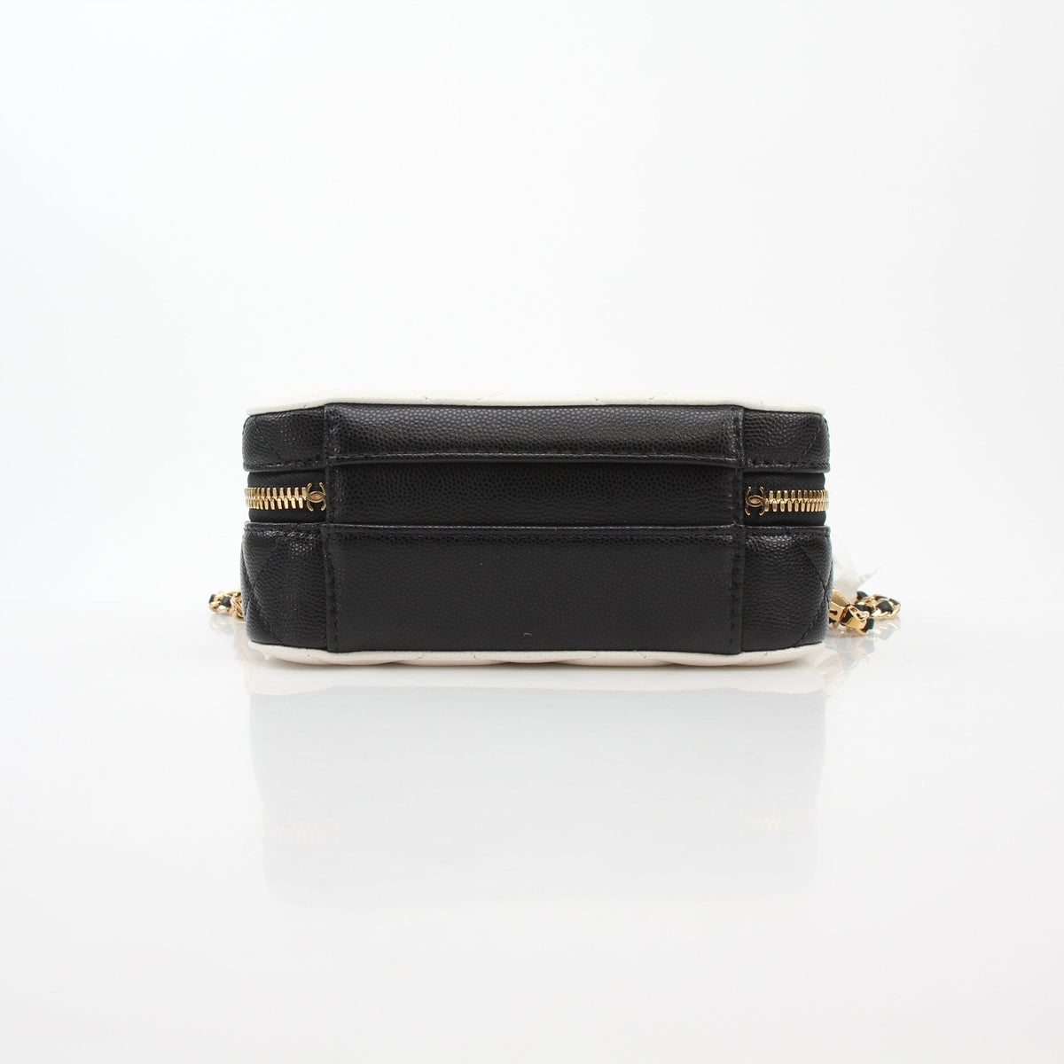 Chanel white and black small CC filigree vanity case with gold accents, compact design, and intricate detailing.