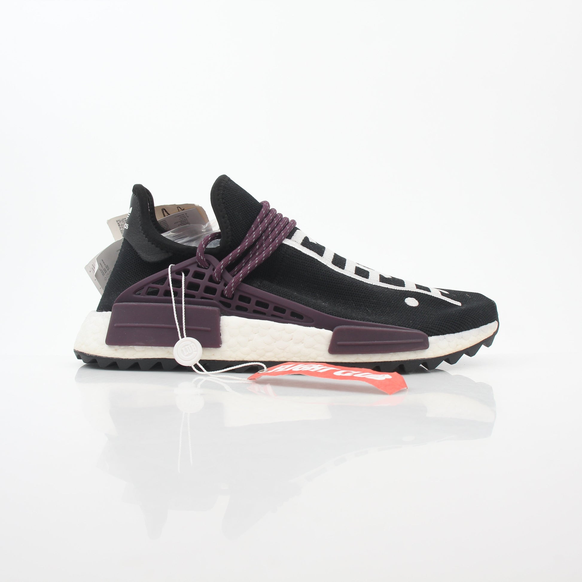 Adidas x Pharrell Williams NMD Hu Trail Holi Equality sneakers in vibrant colors, displayed on a white background.