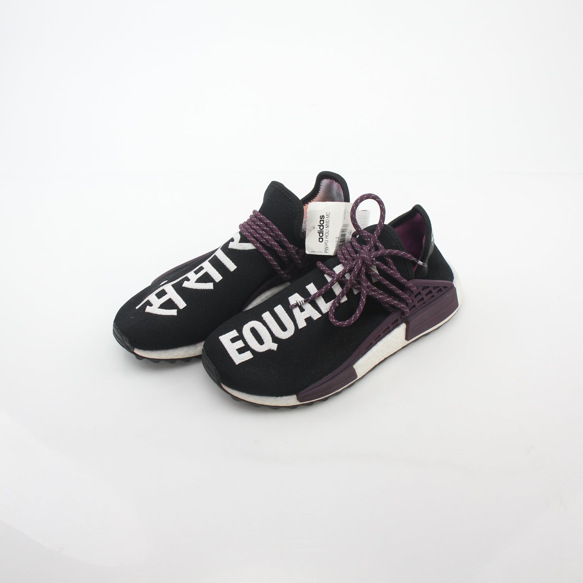 Adidas x Pharrell Williams NMD Hu Trail Holi Equality sneakers in vibrant colors, displayed on a white background.