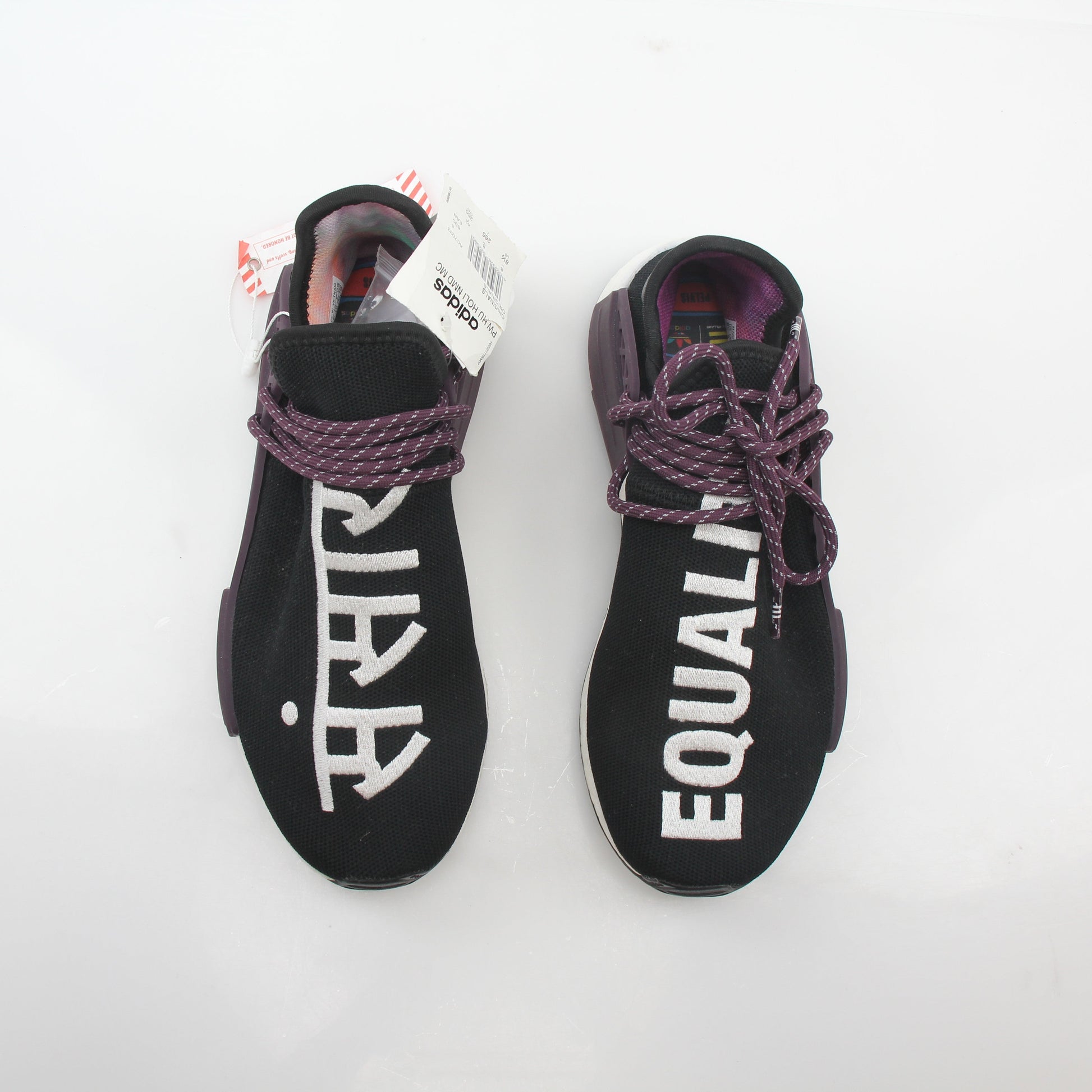 Adidas x Pharrell Williams NMD Hu Trail Holi Equality sneakers in vibrant colors, showcasing the shoe's design and branding details.