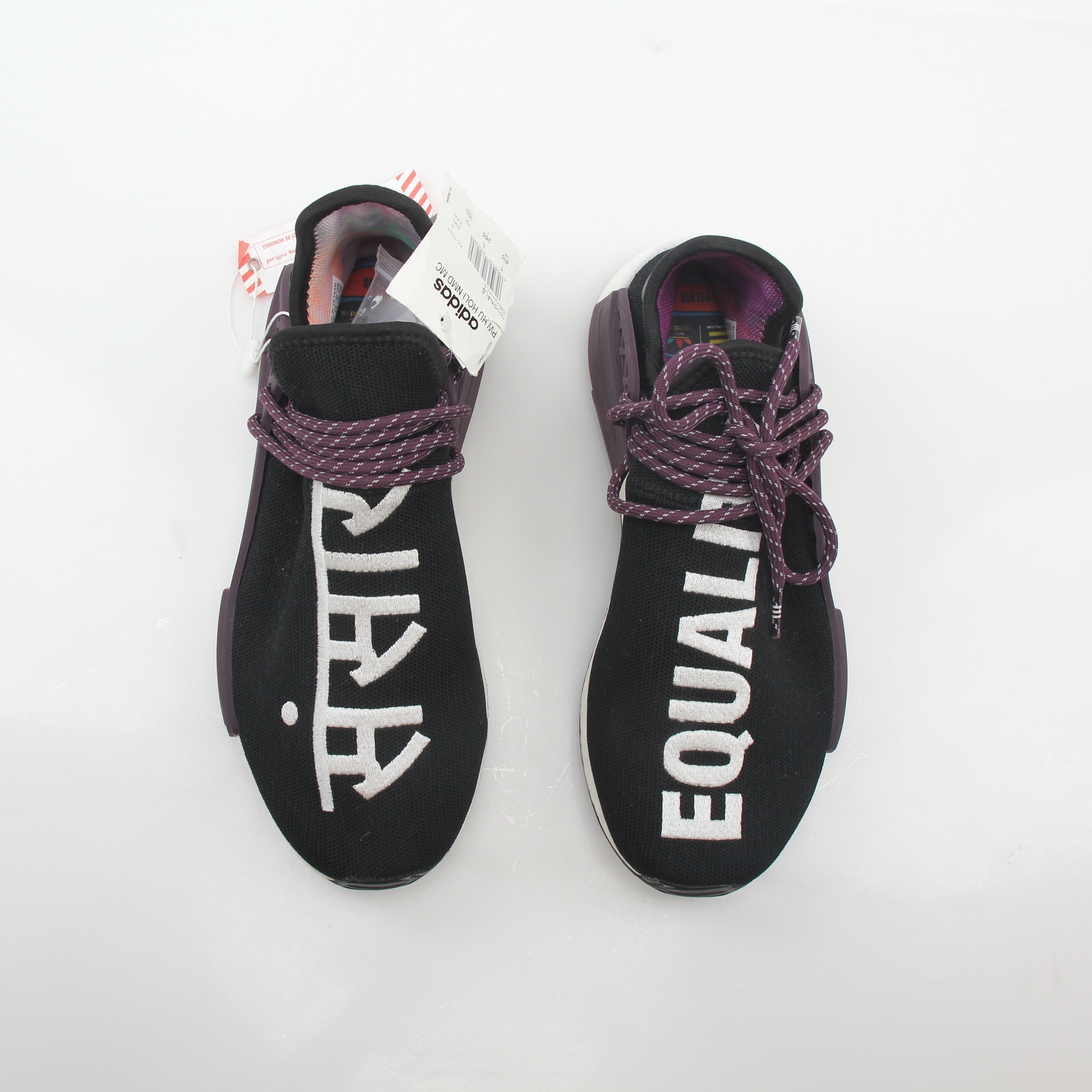 Adidas x Pharrell Williams NMD Hu Trail Holi Equality sneakers in vibrant colors, showcasing the shoe's design and branding details.