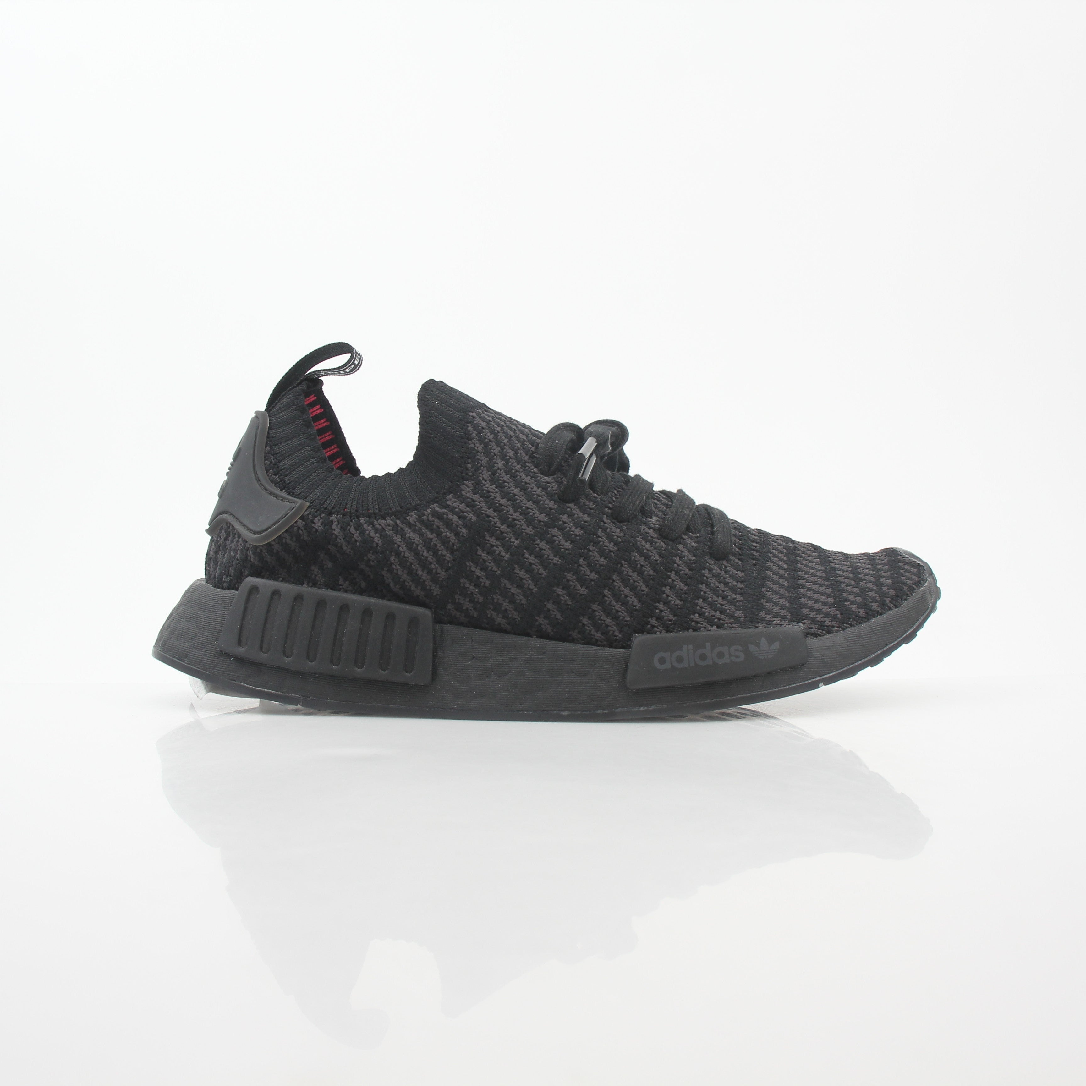 Adidas NMD R1 STLT Triple Black Primeknit sneakers with black Boost midsole and sleek design, displayed on a white background.
