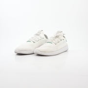 Adidas x Pharrell Williams Tennis Hu white and green sneakers with white laces and stylish design.