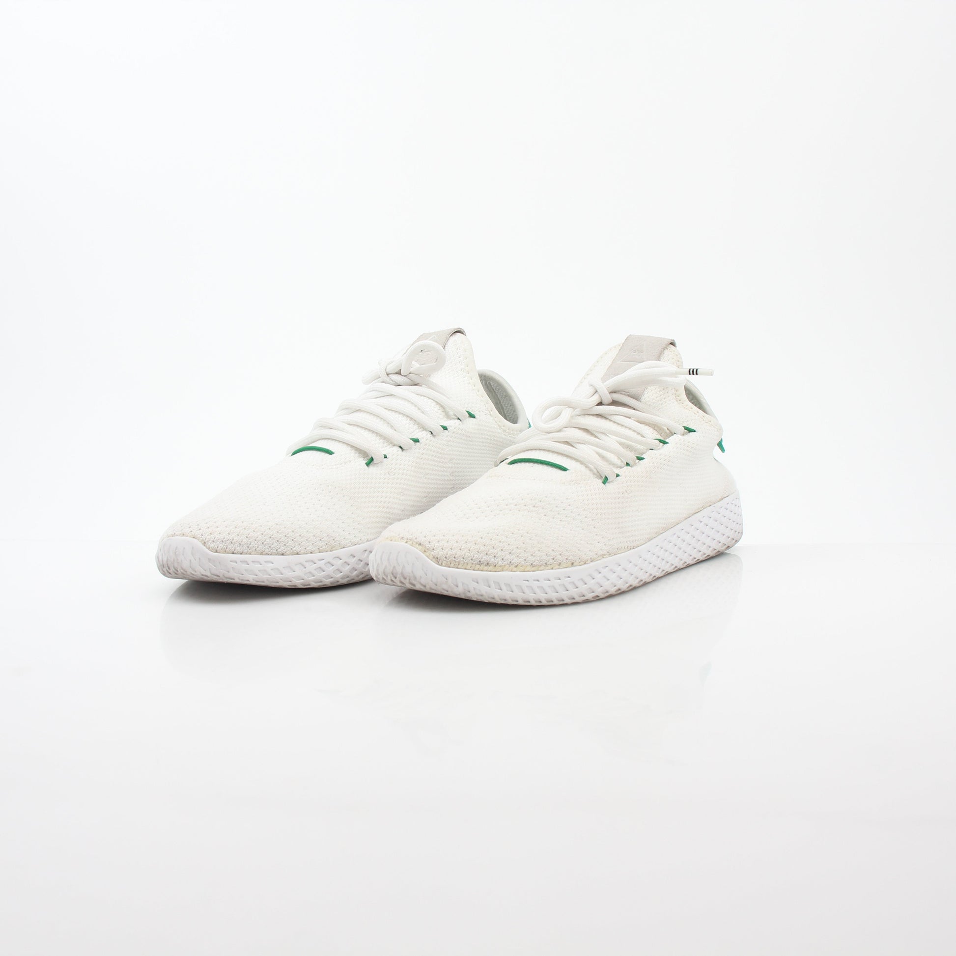 Adidas x Pharrell Williams Tennis Hu white and green sneakers with white laces and stylish design.