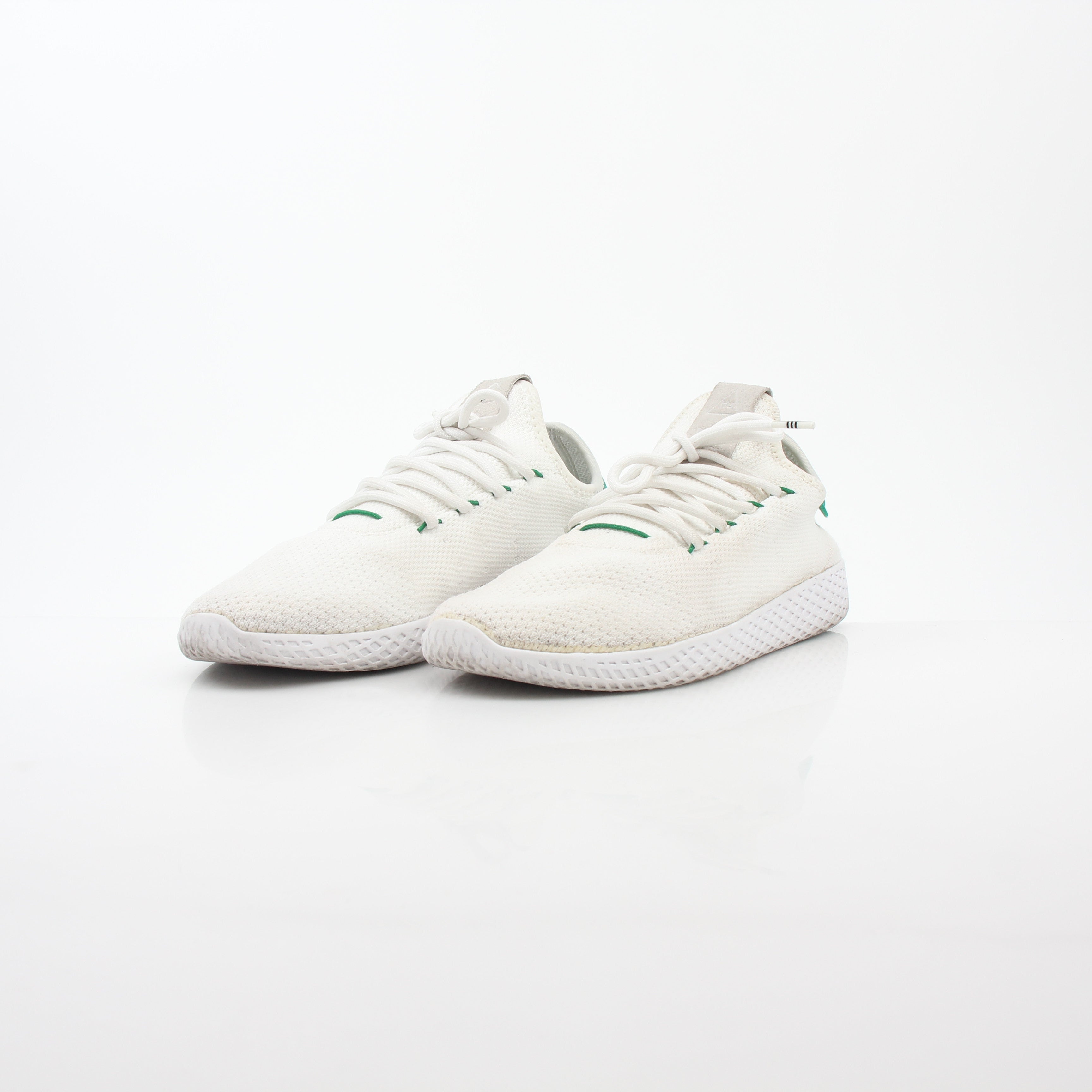 Adidas x Pharrell Williams Tennis Hu white and green sneakers with white laces and stylish design.