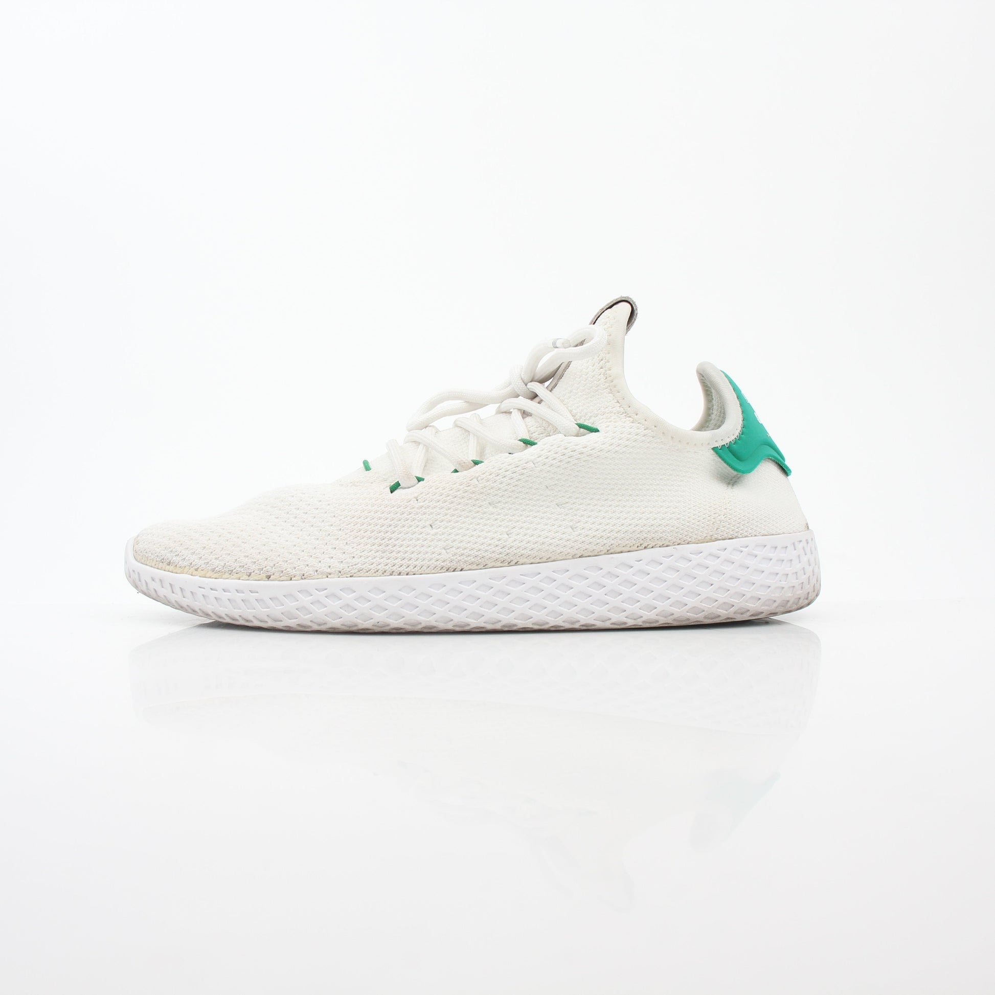 Adidas x Pharrell Williams Tennis Hu white and green sneakers with sleek design and breathable material.