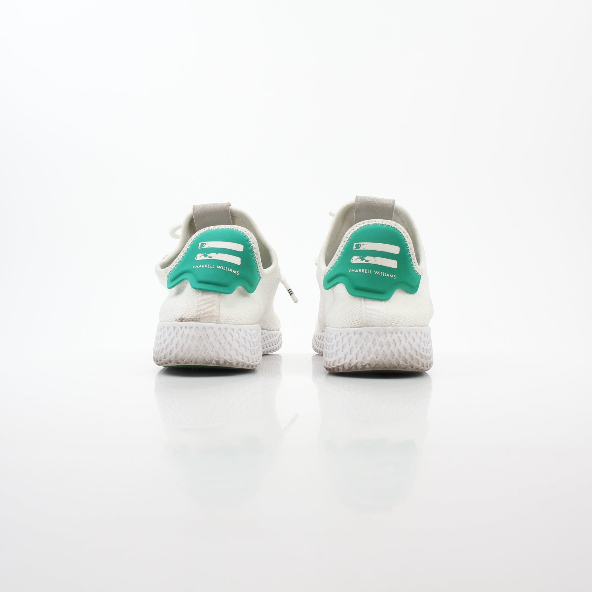 Adidas x Pharrell Williams Tennis Hu white and green sneakers with sleek design and sporty style.