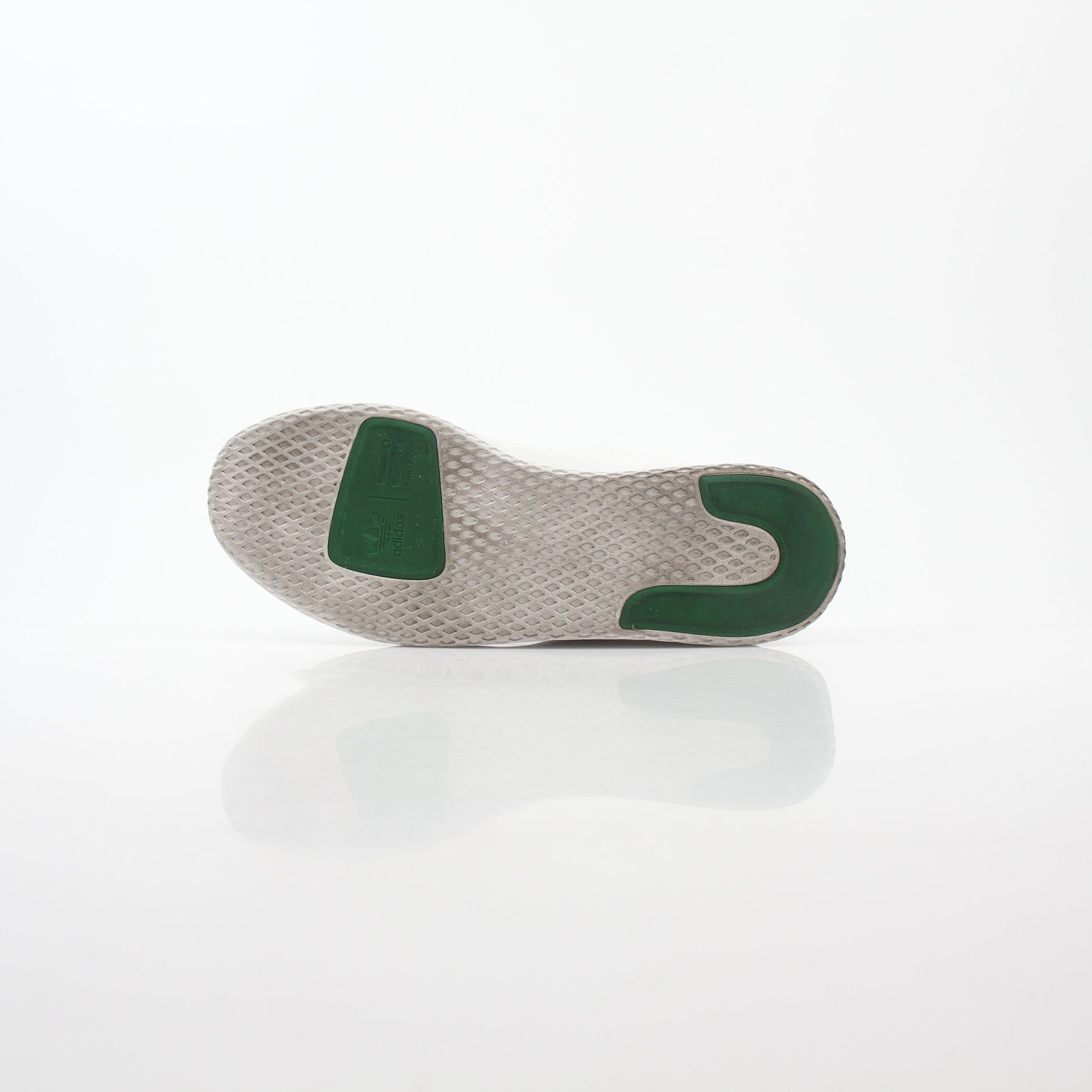 White and green Adidas Pharrell Williams Tennis Hu sneakers with textured design and lace-up closure.