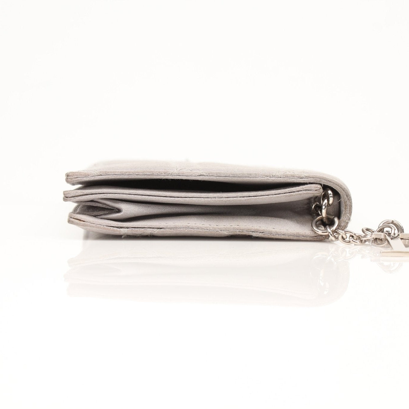 Gray satin Christian Dior Cannage clutch wallet with gold accents, featuring a quilted pattern and elegant design.