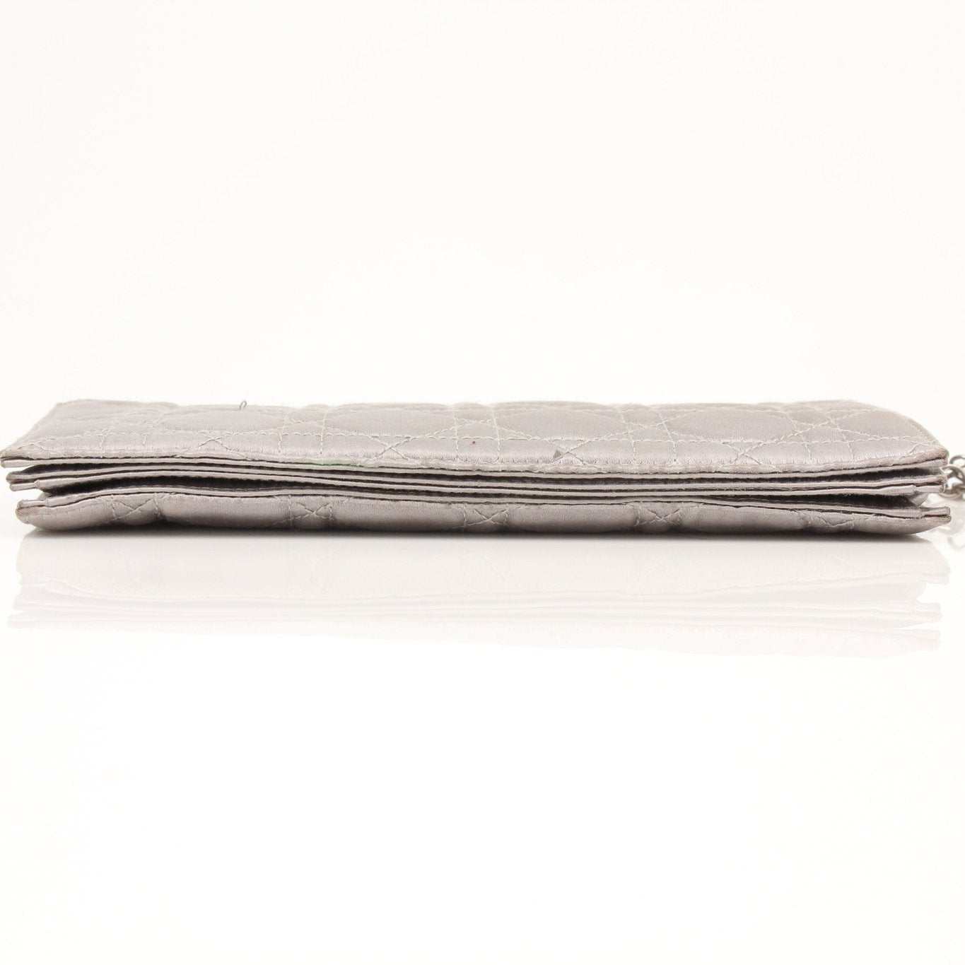 Gray satin Christian Dior Cannage clutch wallet with gold hardware and quilted design, featuring a sleek, elegant look.
