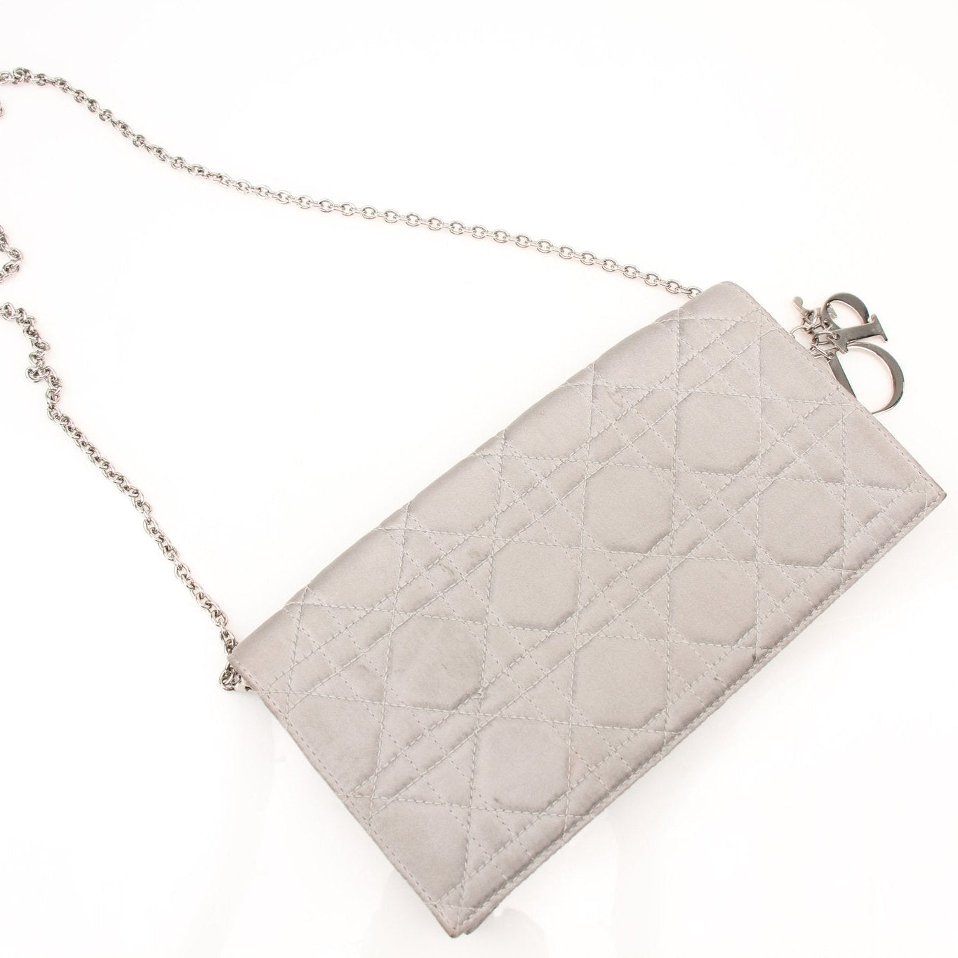 Christian Dior gray satin Cannage clutch wallet with gold accents, featuring a quilted design and elegant compact shape.