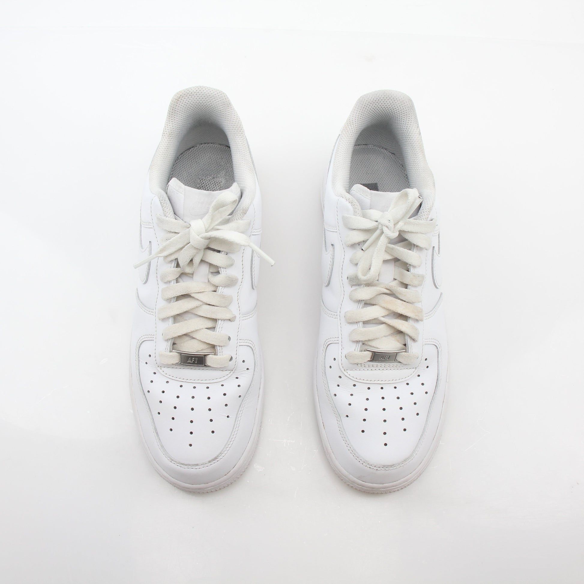 Nike White Air Force 1 ’07 Low sneakers in a close-up view showcasing the classic design and white leather upper.