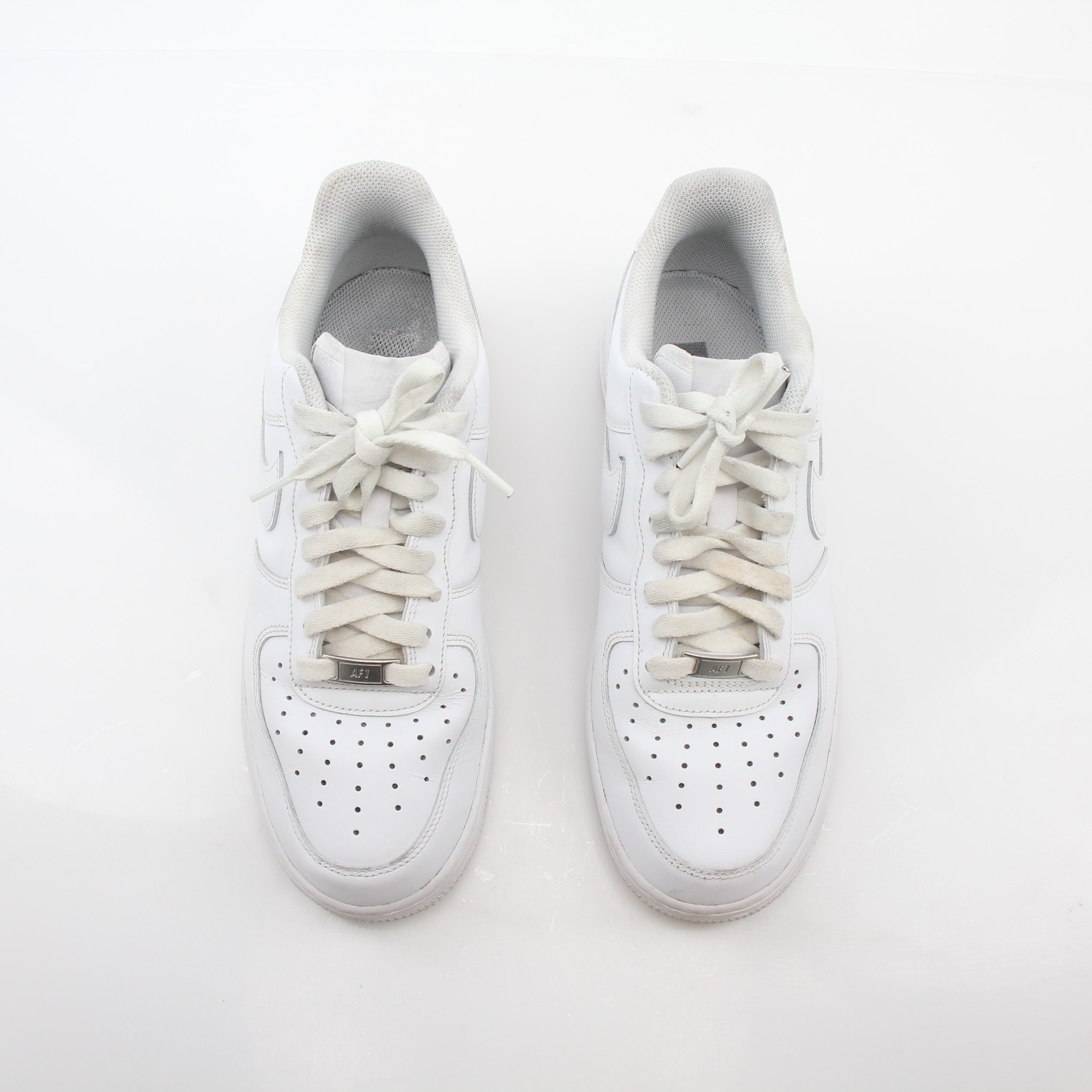 Nike White Air Force 1 ’07 Low sneakers in a close-up view showcasing the classic design and white leather upper.