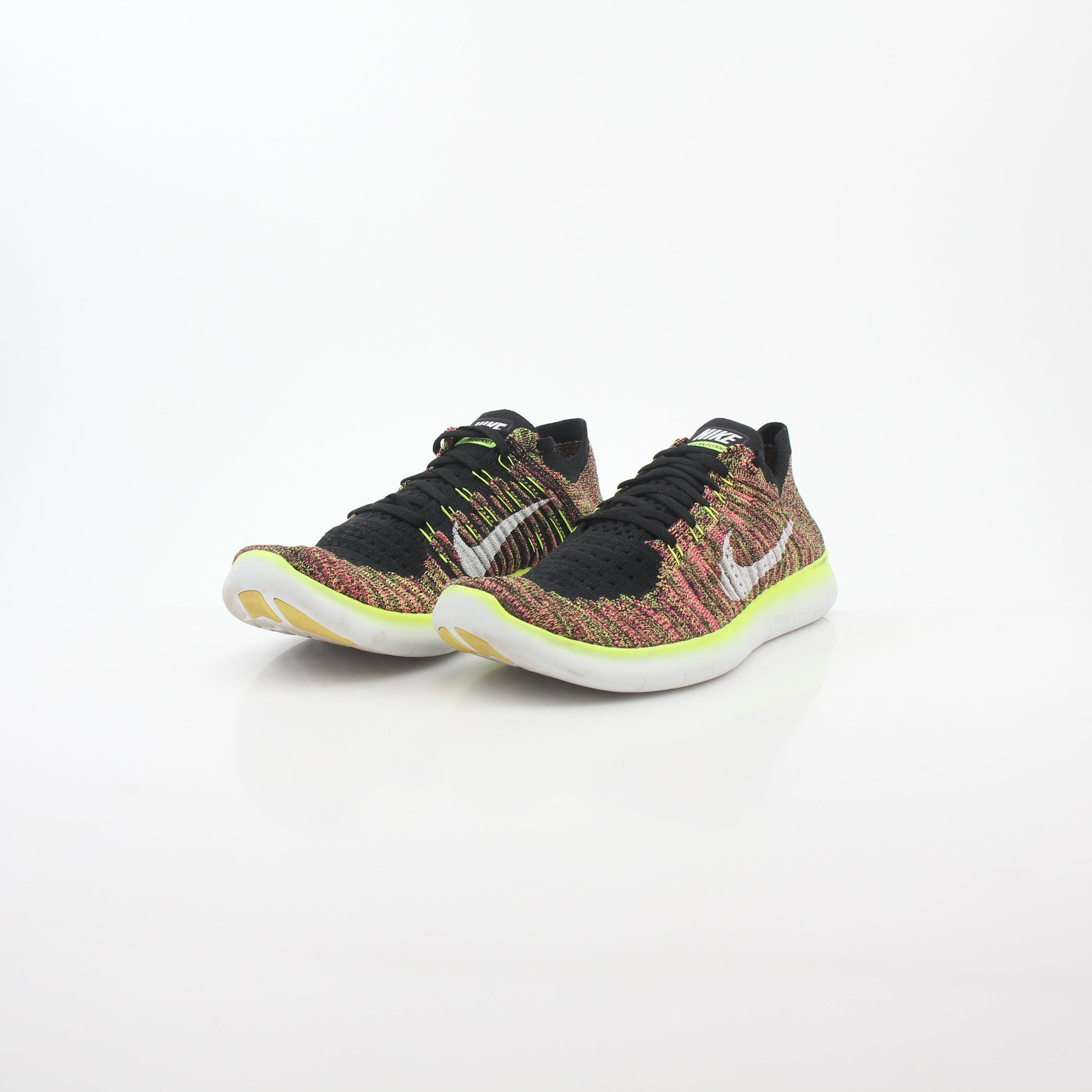 Nike Free RN Flyknit Unlimited Olympic multicolor sneakers in a side view showing the lightweight flyknit upper and athletic design.