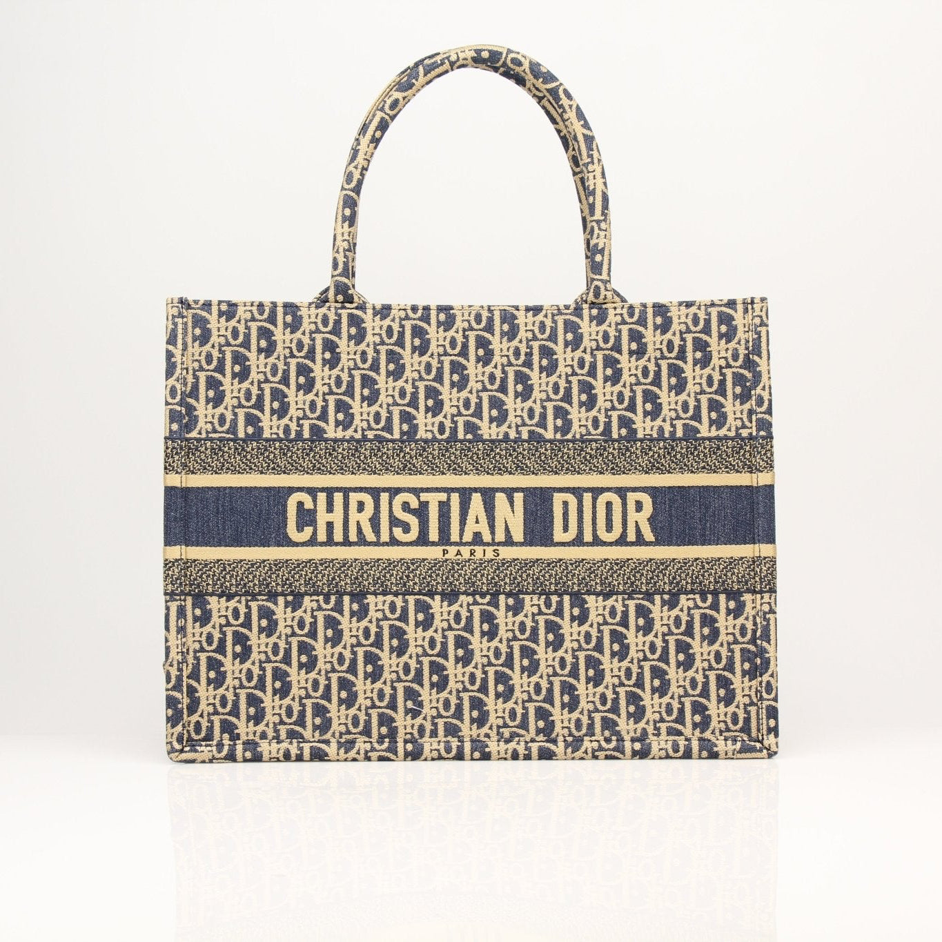 Christian Dior Oblique Book Tote handbag with beige and brown monogram canvas, featuring leather handles and gold-tone hardware.