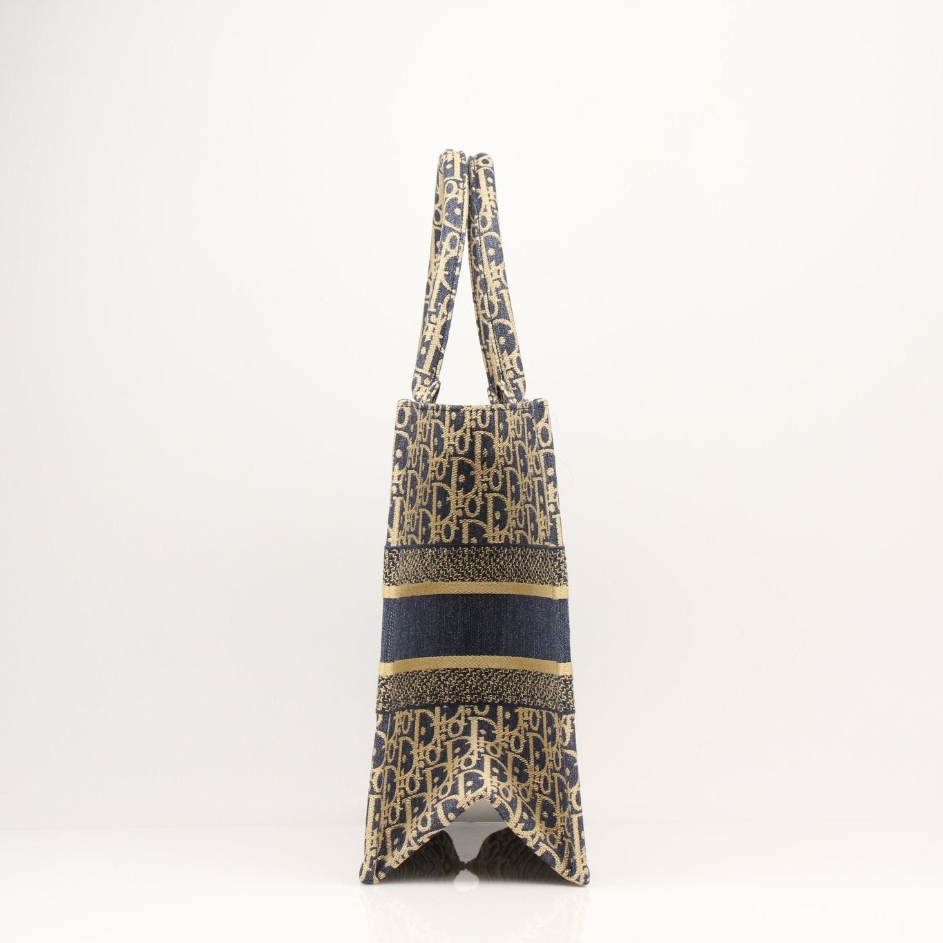 Christian Dior Oblique Book Tote handbag with beige canvas and brown leather handles, showcasing its iconic monogram design.