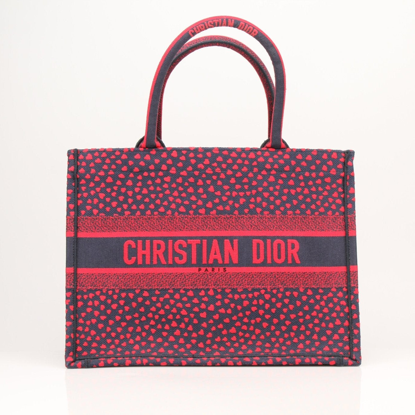 Christian Dior Book Tote handbag with heart embroidery, featuring stylish design and prominent logo, by Gold & Beyond.