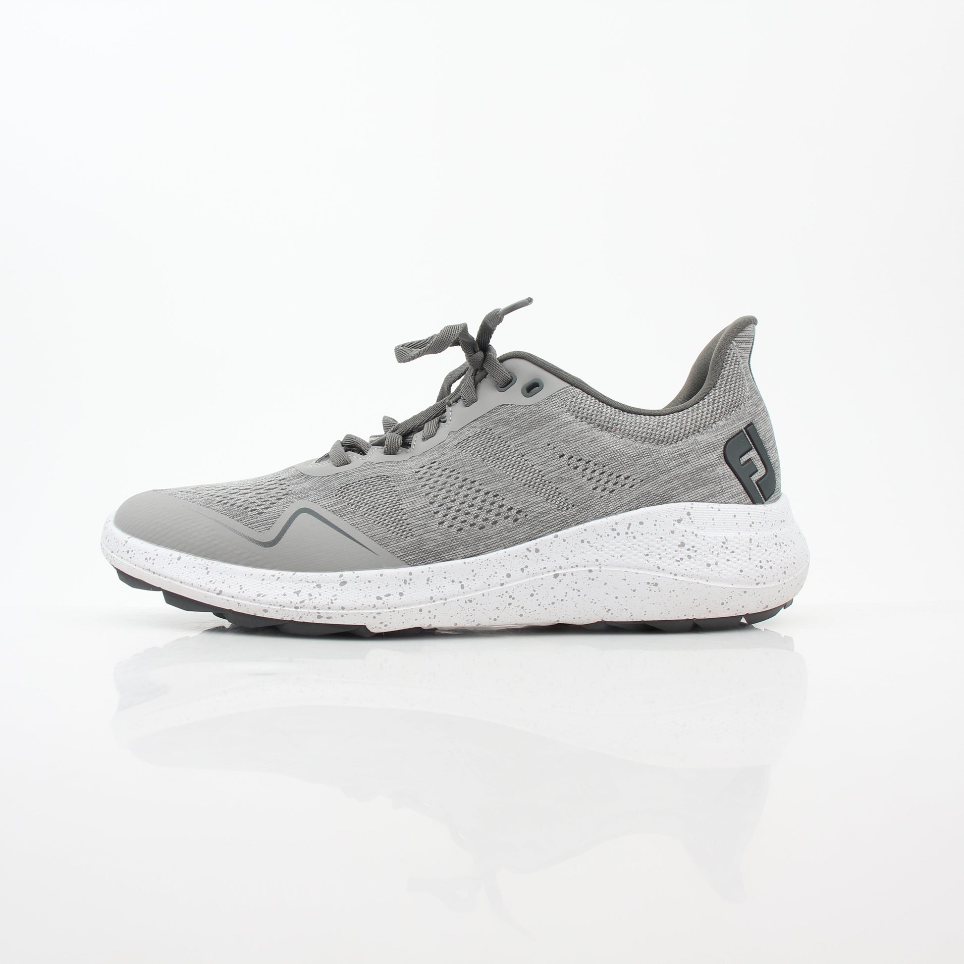 Gray FootJoy Flex spikeless golf shoes with a sleek design and comfortable fit, featuring Gold & Beyond branding.