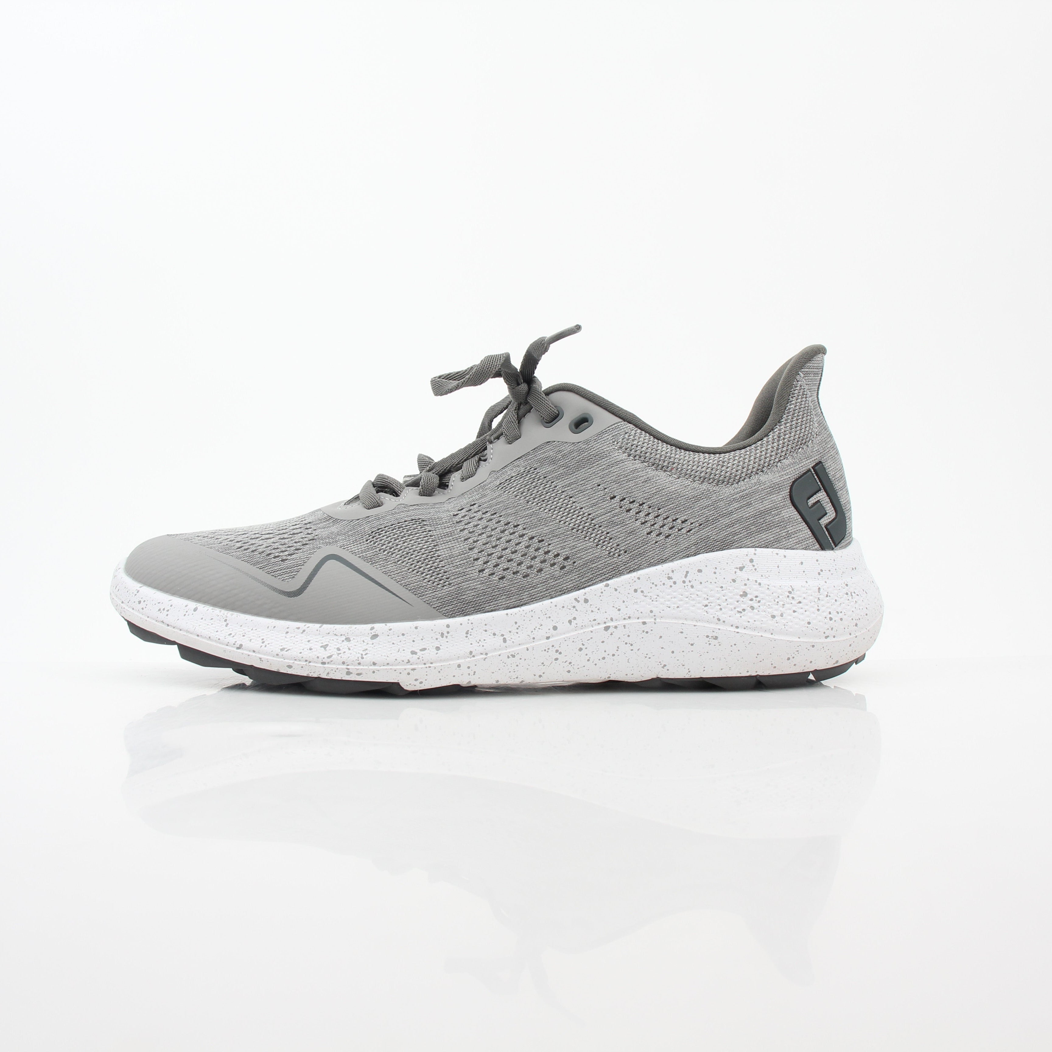 Gray FootJoy Flex spikeless golf shoes with a sleek design and comfortable fit, featuring Gold & Beyond branding.
