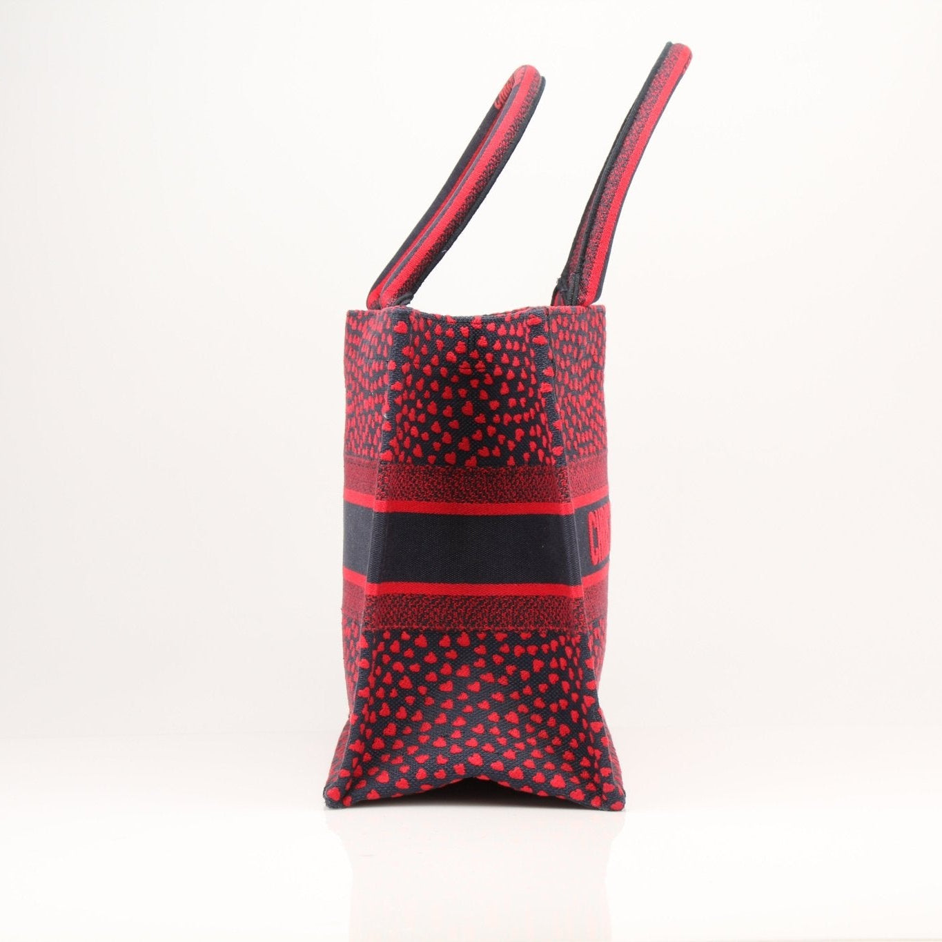 Christian Dior Book Tote handbag with heart embroidery, featuring a spacious design and intricate stitched details.