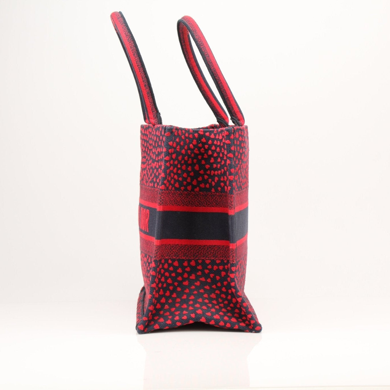 Christian Dior Book Tote handbag with heart embroidery, featuring a spacious design and luxurious craftsmanship.