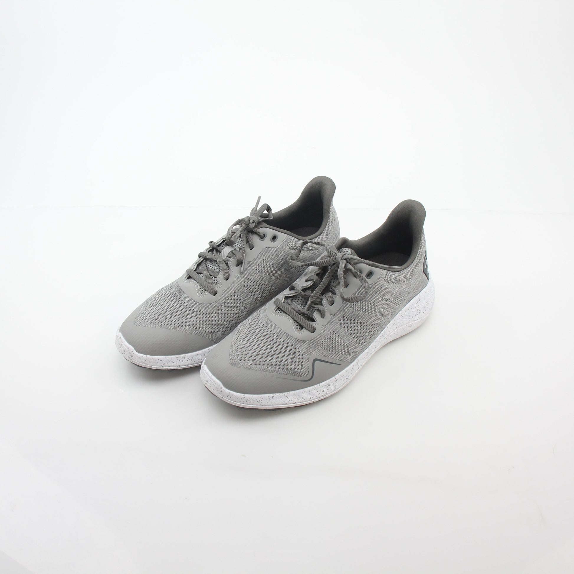 Gray FootJoy Flex spikeless golf shoes with sleek design and comfortable fit, featuring Gold & Beyond branding.