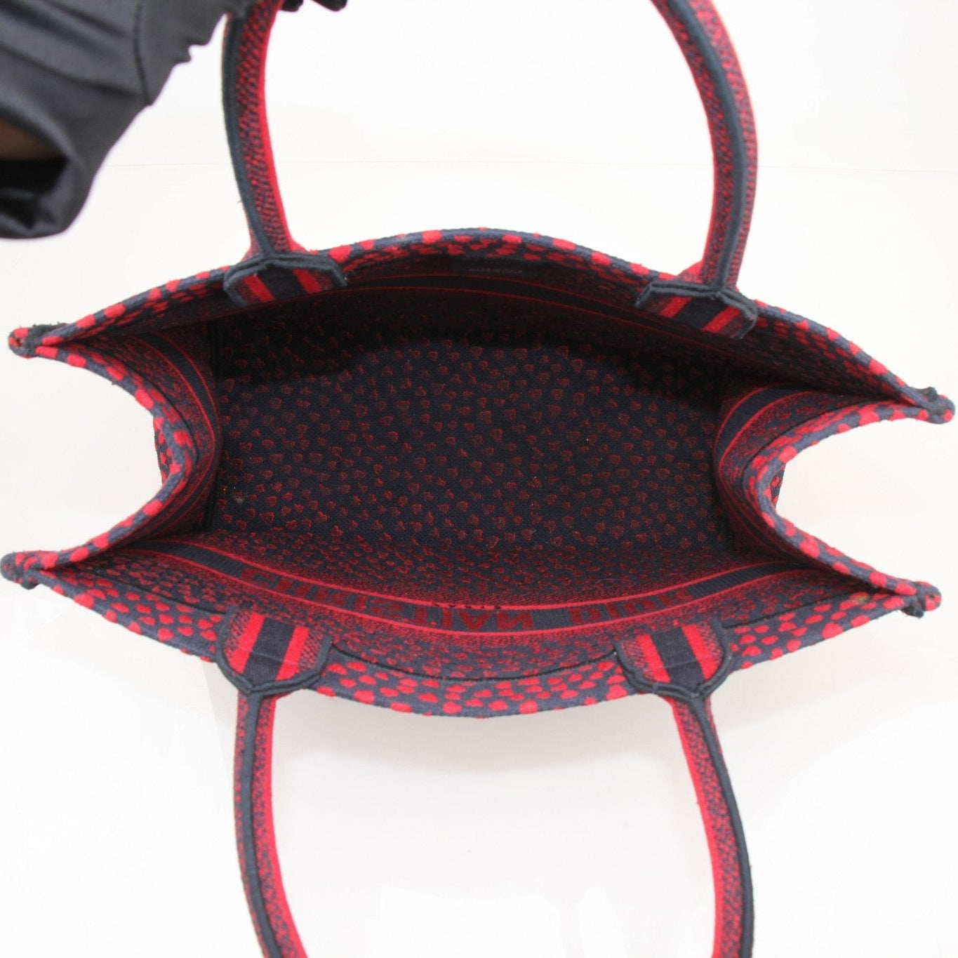 Christian Dior Book Tote handbag with heart embroidery, featuring a stylish and spacious design in the image.