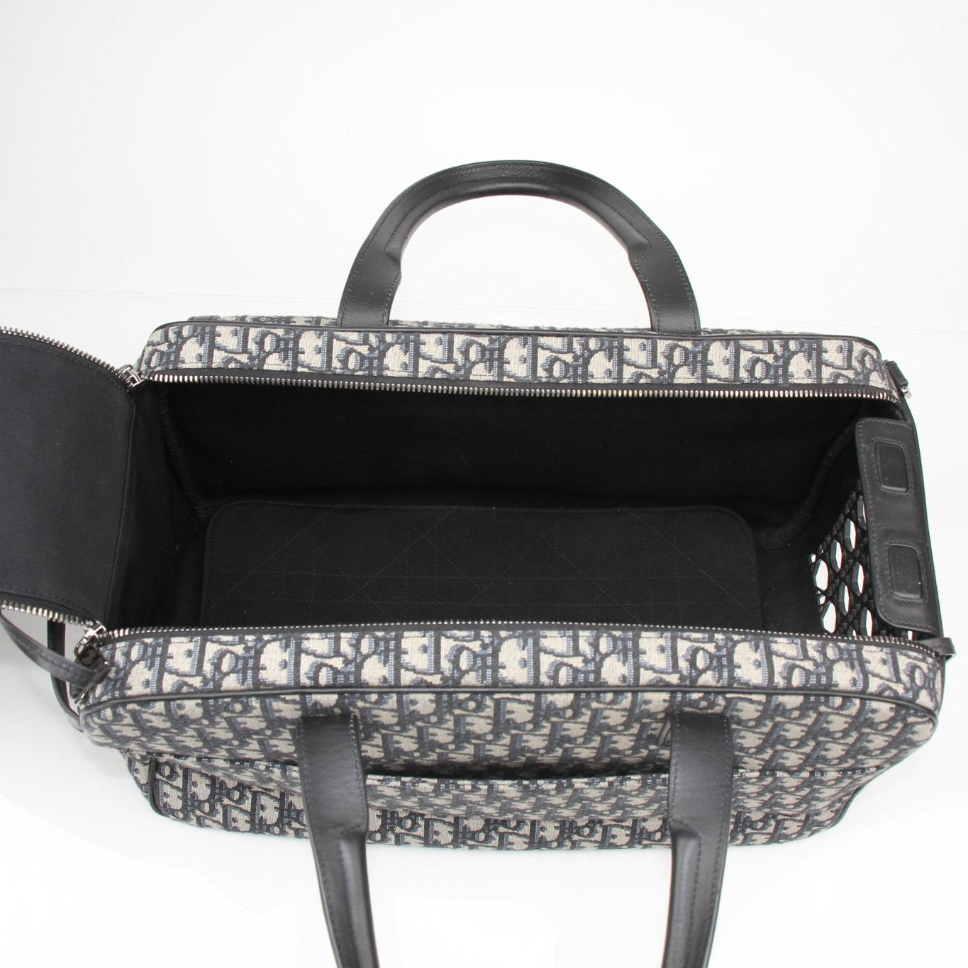 Christian Dior Oblique dog carrier travel bag with gold accents and adjustable straps, designed for stylish pet travel.