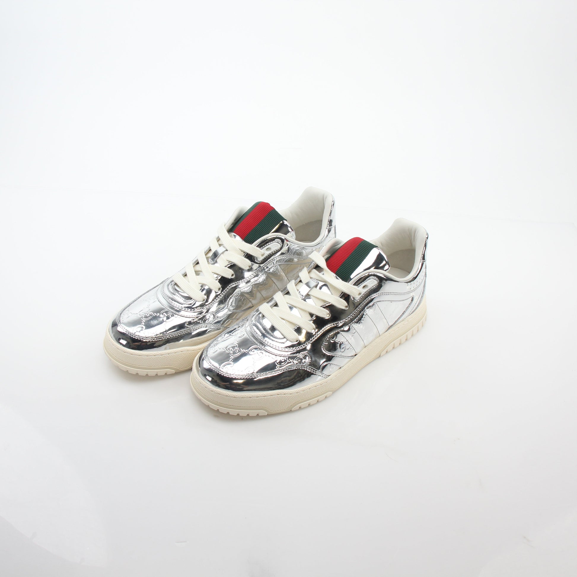Gucci silver metallic Re-Web sneakers with a sleek design, featuring the iconic web detail and modern athletic style.