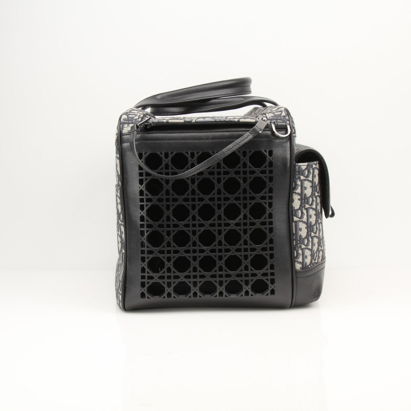 Christian Dior Oblique dog carrier travel bag with gold accents and adjustable strap, designed for stylish pet transportation.
