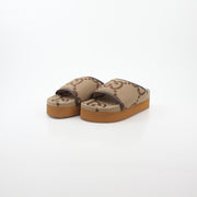Gucci brown maxi GG platform slide sandals with open toe and thick sole, displayed on a neutral background.