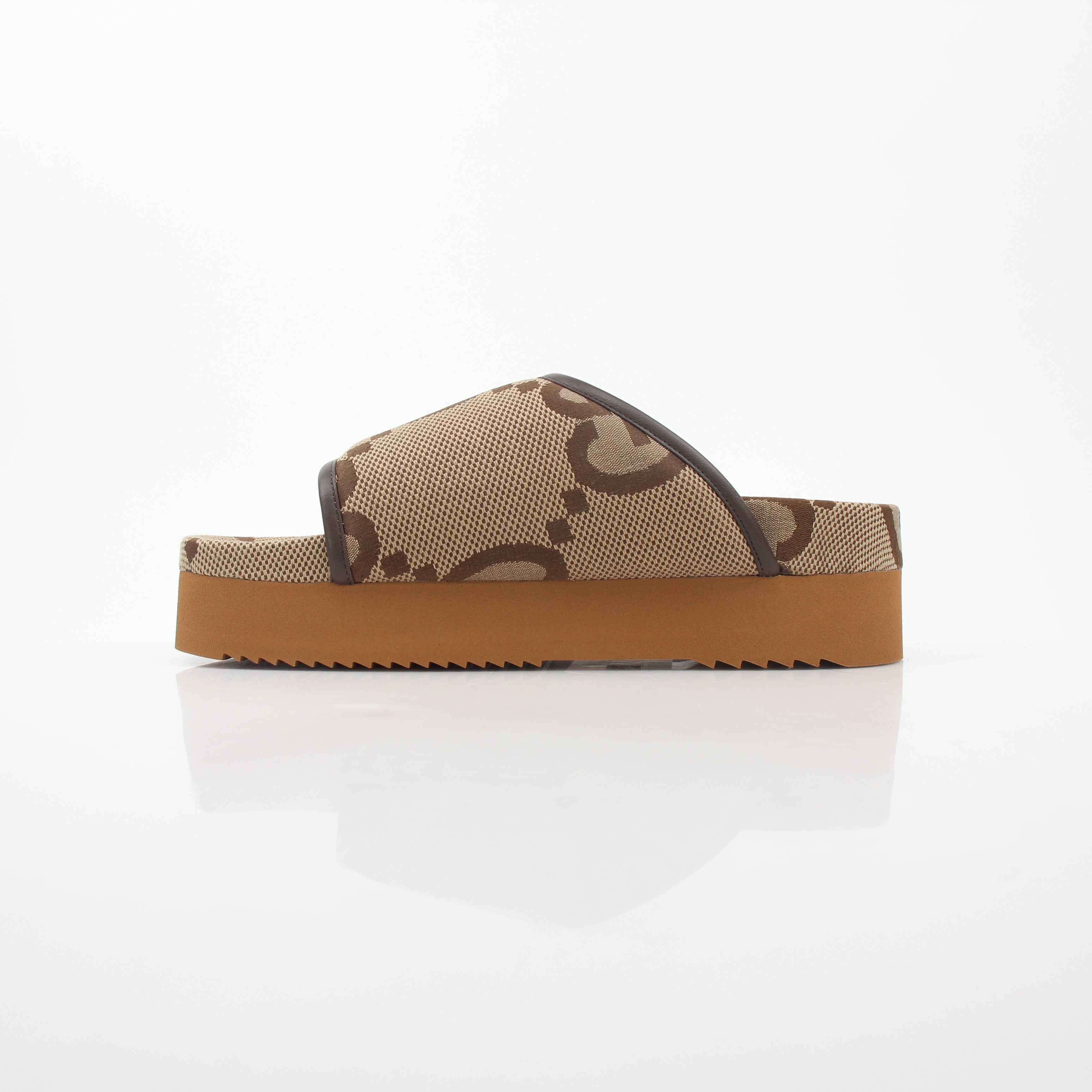 Gucci brown maxi GG platform slide sandals with thick soles and wide straps, displayed on a white background.