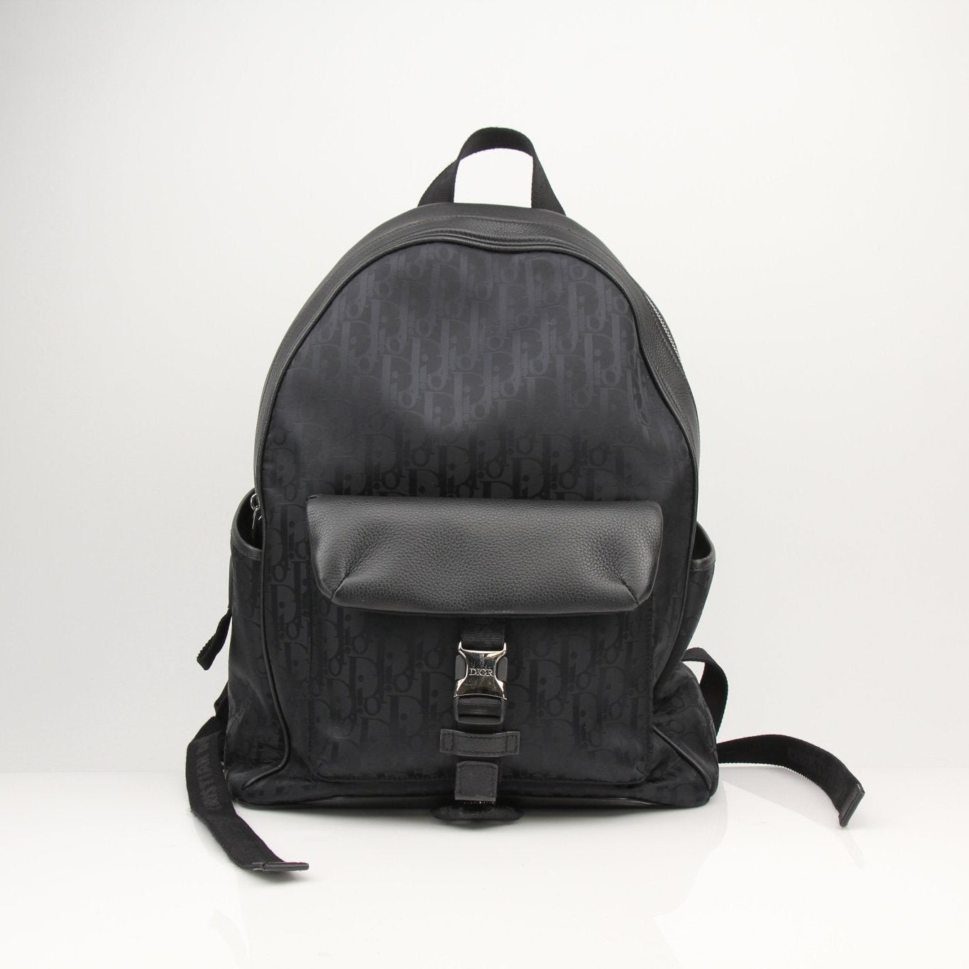 Christian Dior Oblique nylon backpack with adjustable straps and top handle, stylish travel bag with Dior logo pattern.