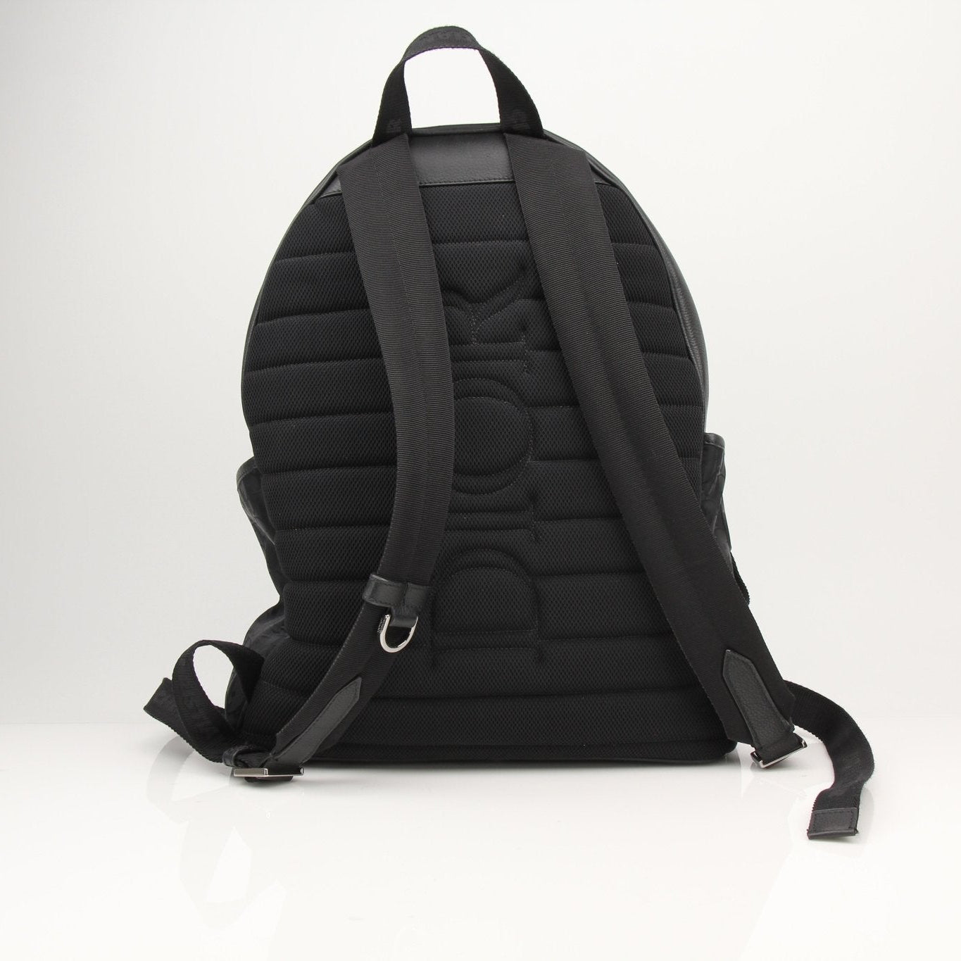 Christian Dior Oblique nylon backpack with adjustable straps and gold-tone logo, ideal for travel and everyday use.