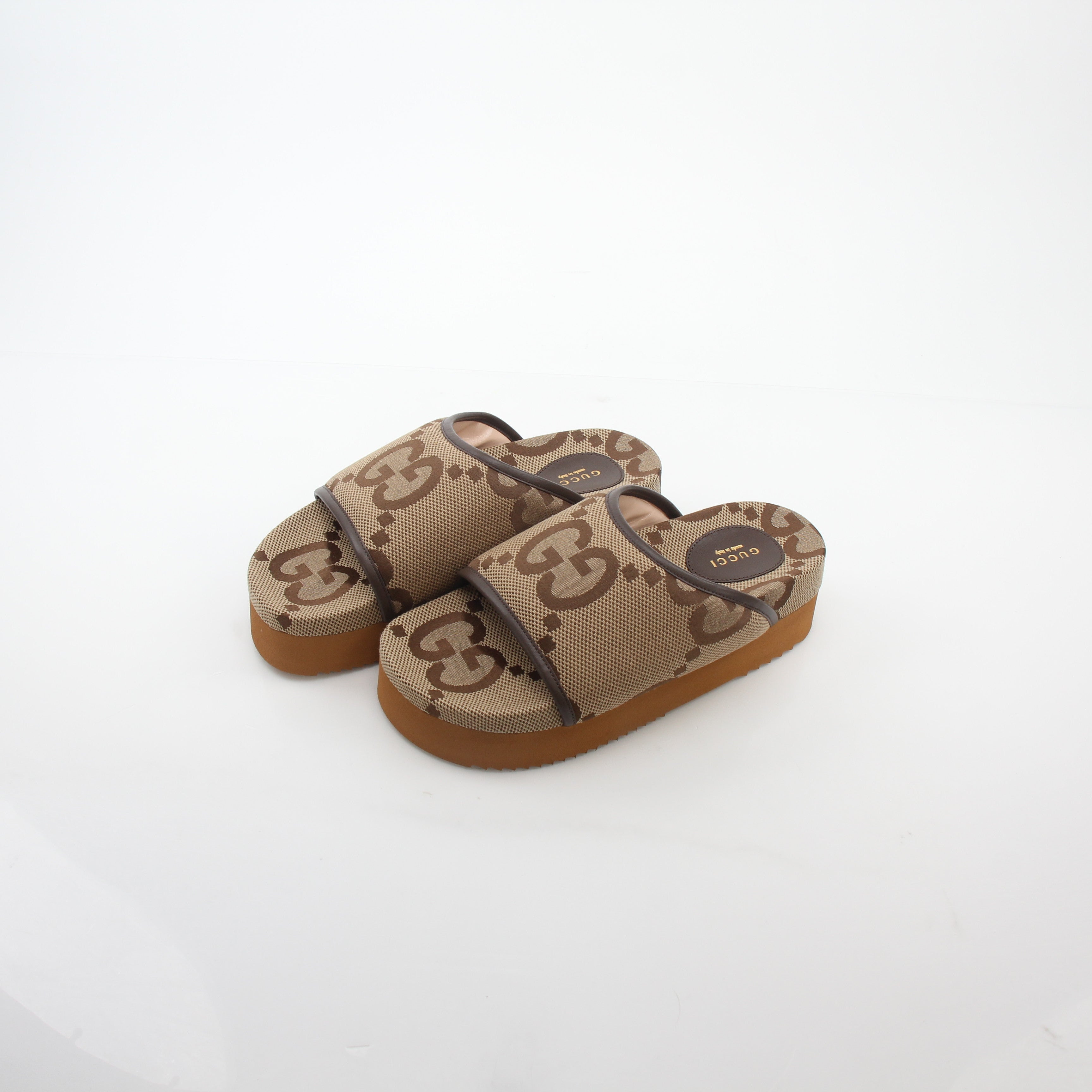 Gold & Beyond Gucci brown maxi GG platform slide sandals with open toe and chunky sole, stylish footwear for casual wear.